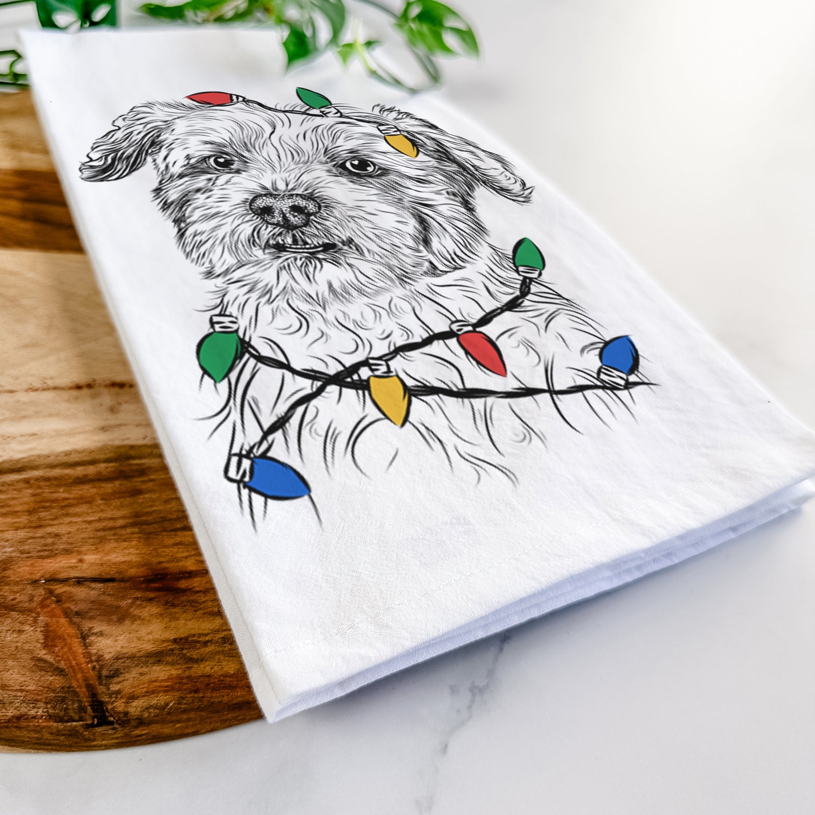 Hand-drawn sketch of Roxie the Schnauzer Shih Tzu Mix wrapped in Christmas lights on a tea towel