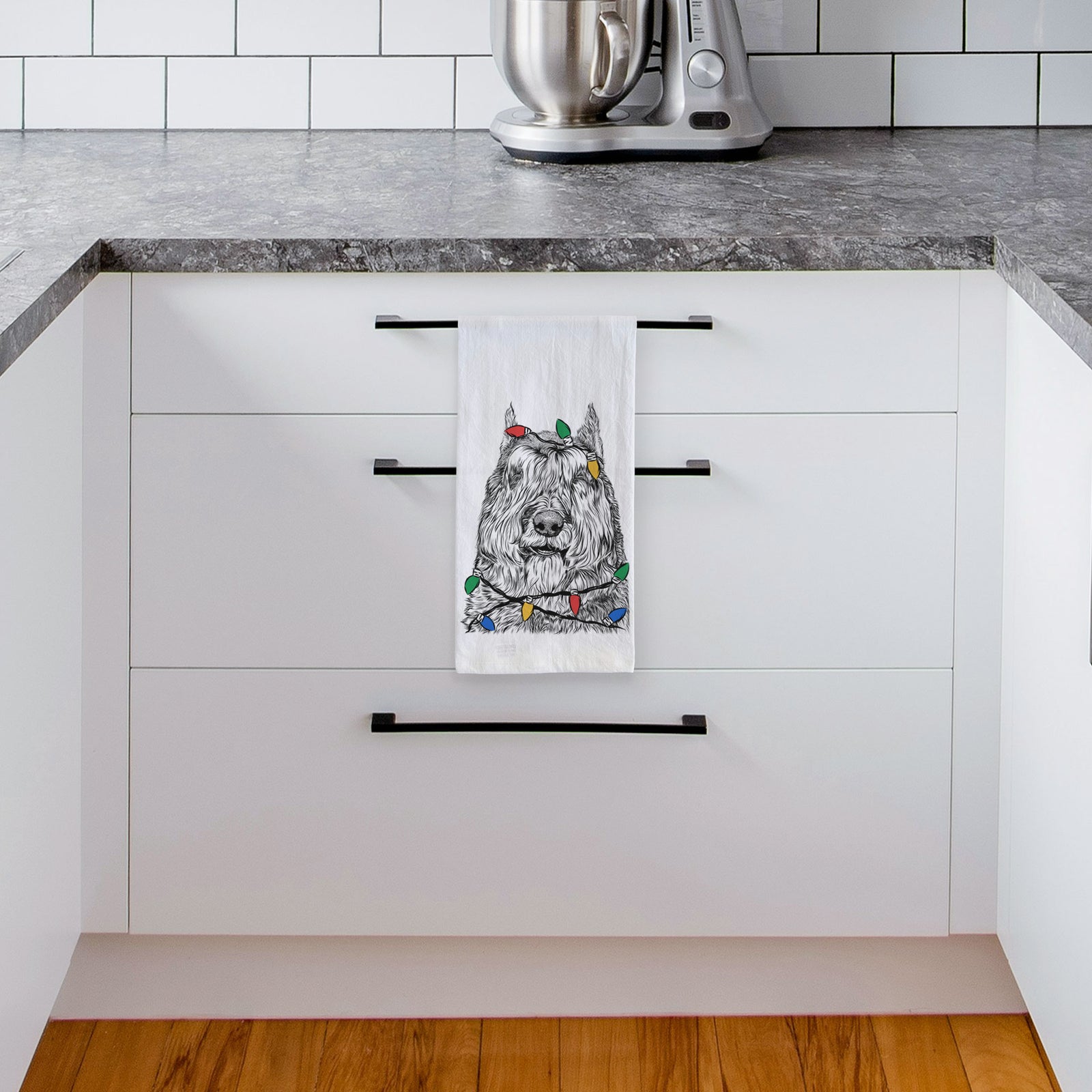 Hand-drawn sketch of Sabre the Bouvier Des Flandres wrapped in Christmas lights on a tea towel, hanging on an oven door in a kitchen