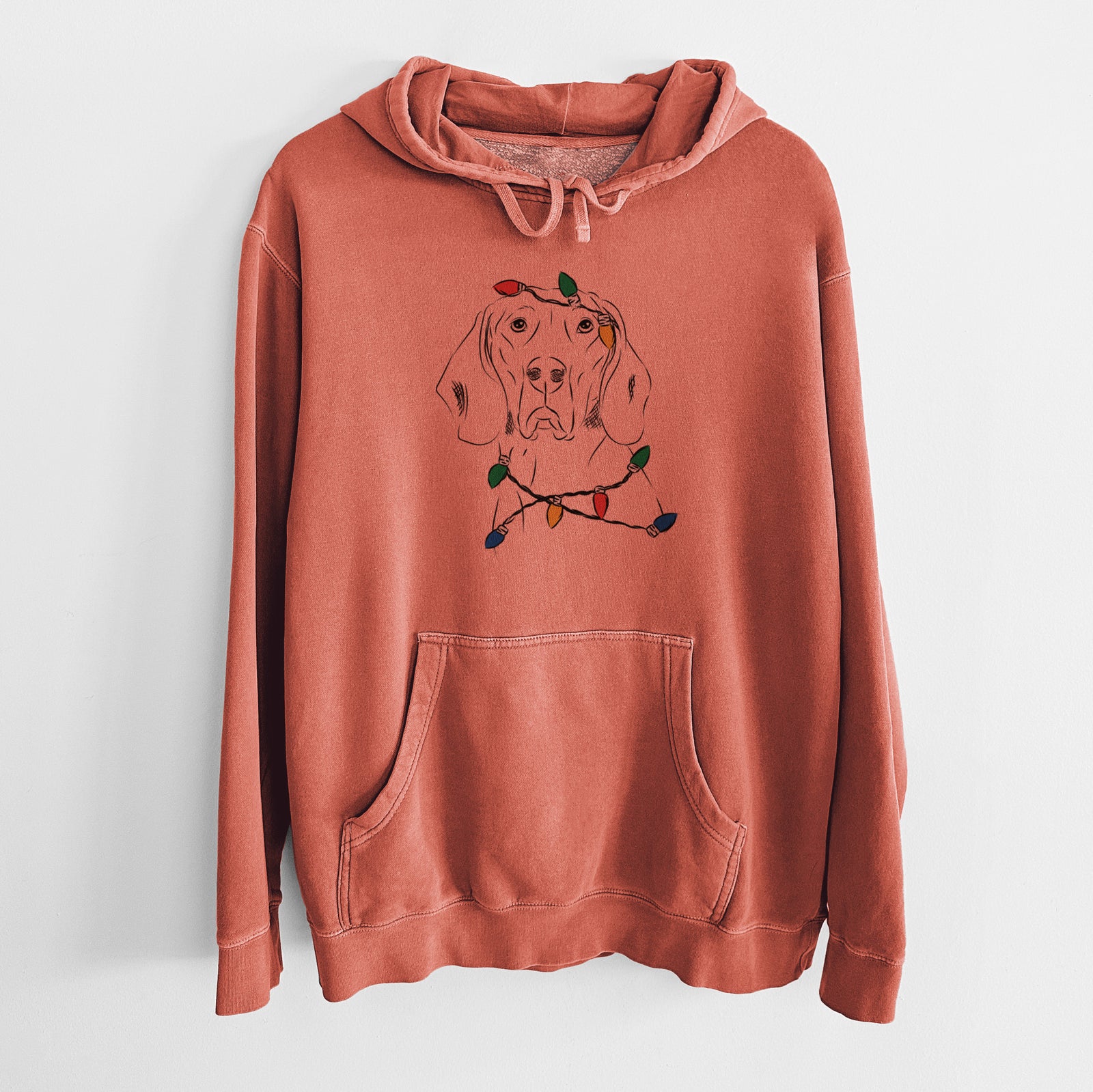 Hand-drawn sketch of Sagan the Coonhound wrapped in Christmas lights on an Amber Unisex pigment dyed hoodie