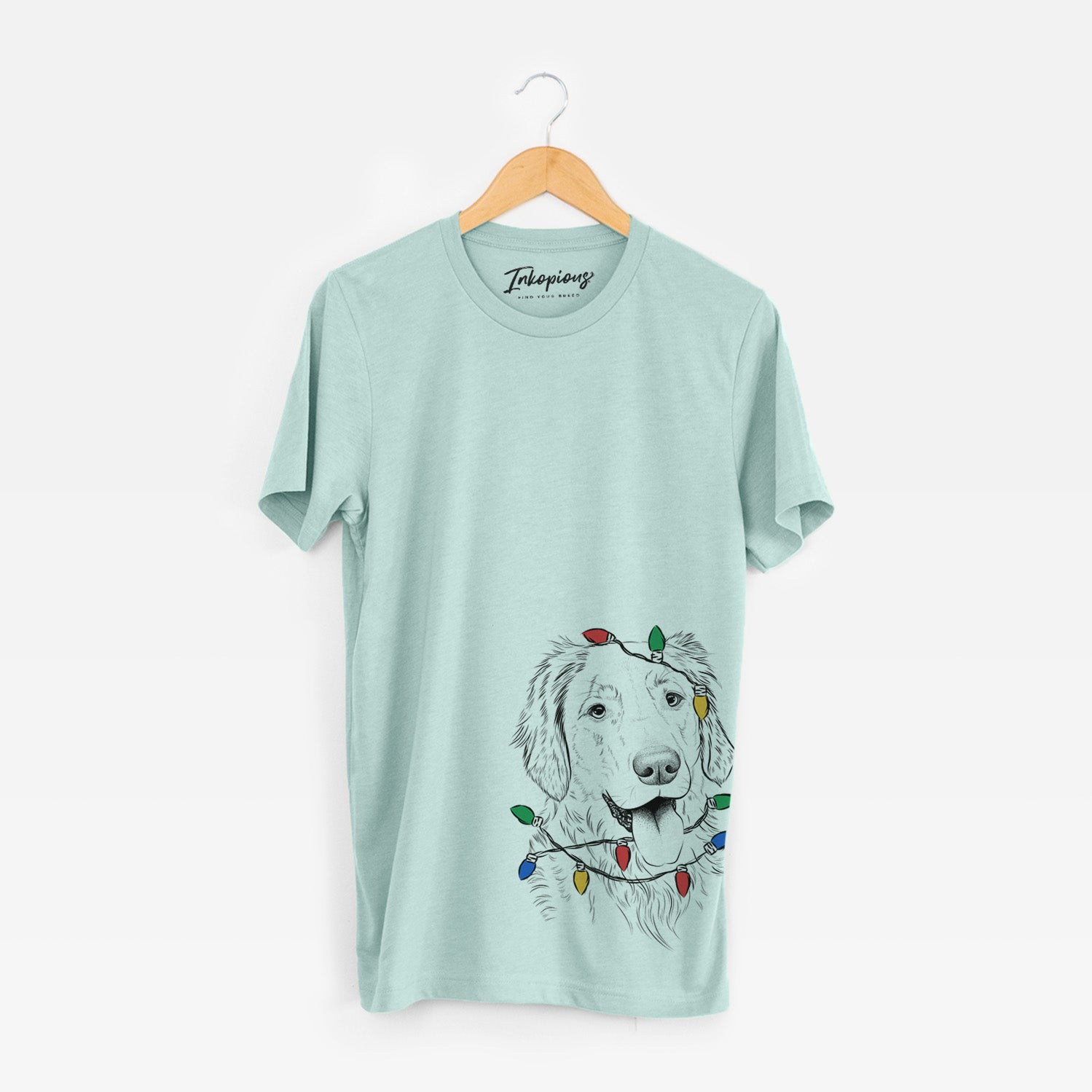 Hand-drawn sketch of Semba the Golden Retriever wrapped in Christmas lights on a Heather Sage Unisex crewneck