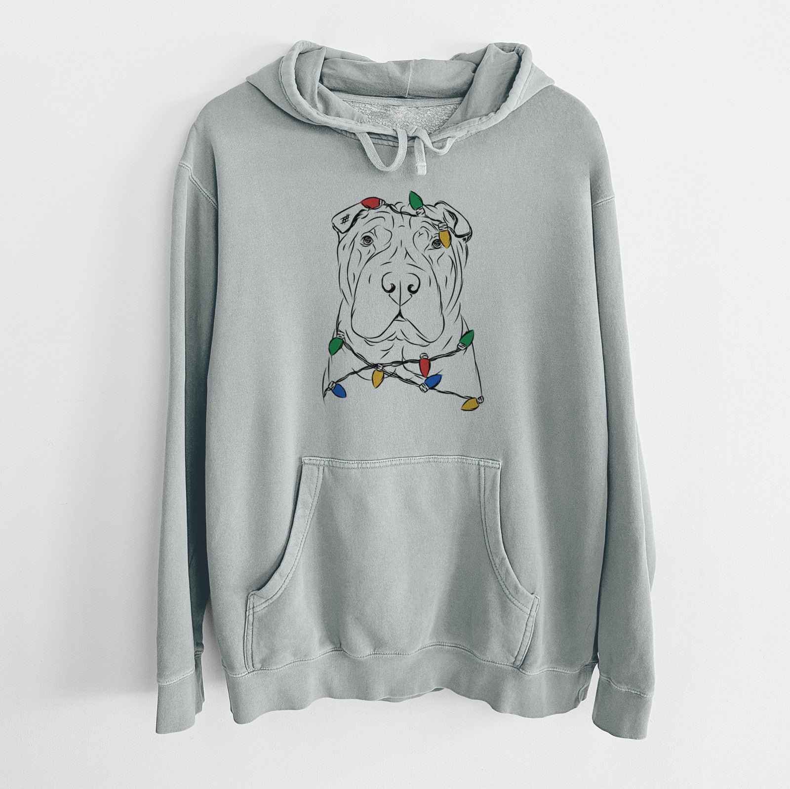Hand-drawn sketch of Sharpy the Shar Pei wrapped in Christmas lights on a Sage Unisex pigment dyed hoodie
