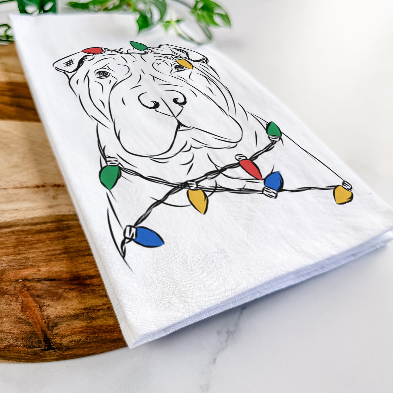 Hand-drawn sketch of Sharpy the Shar Pei wrapped in Christmas lights on a tea towel