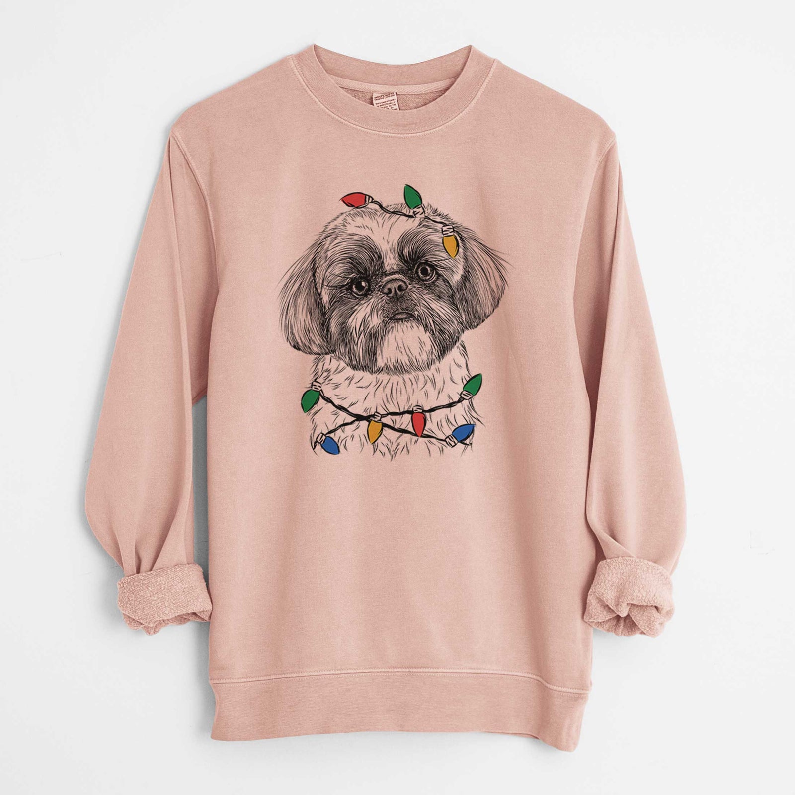 Hand-drawn sketch of Simon the Shih Tzu wrapped in Christmas lights on a Dusty Pink Unisex pigment dyed crew sweatshirt