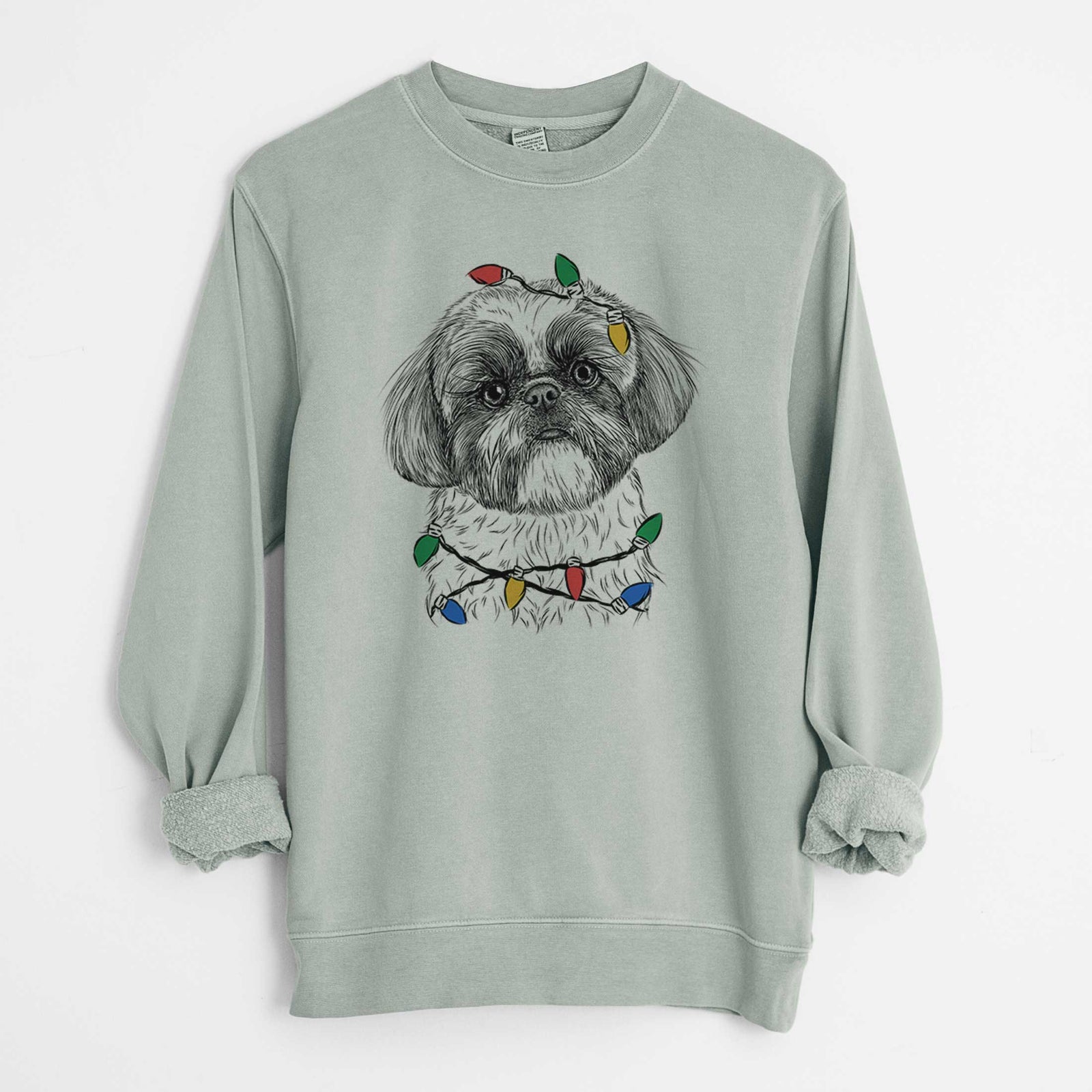 Hand-drawn sketch of Simon the Shih Tzu wrapped in Christmas lights on a Sage Unisex pigment dyed crew sweatshirt