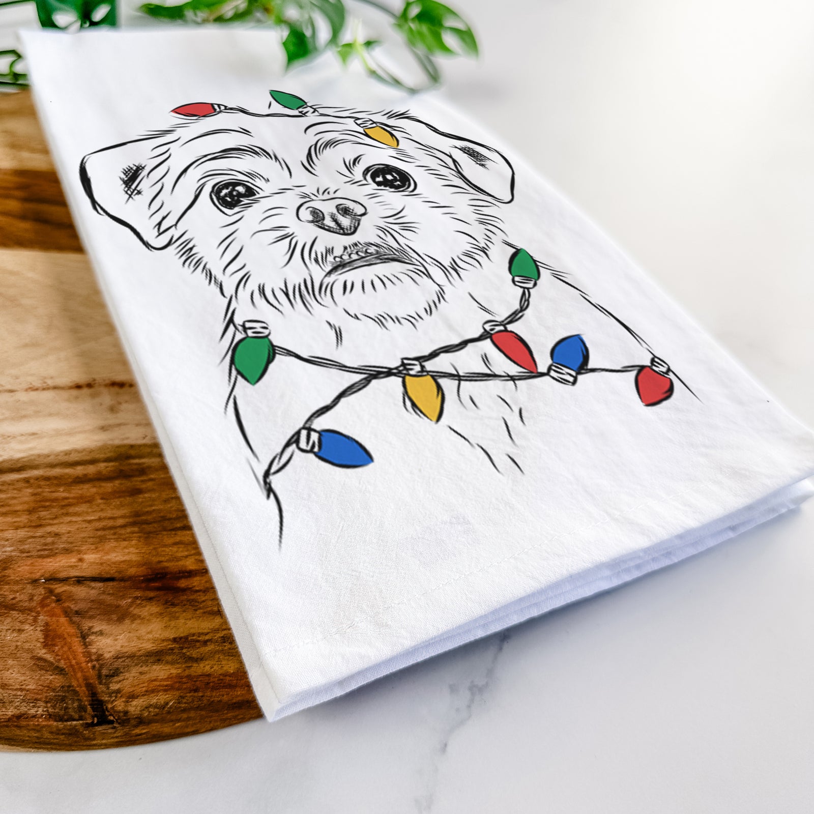 Hand-drawn sketch of Smash the Shih Tzu wrapped in Christmas lights on a tea towel