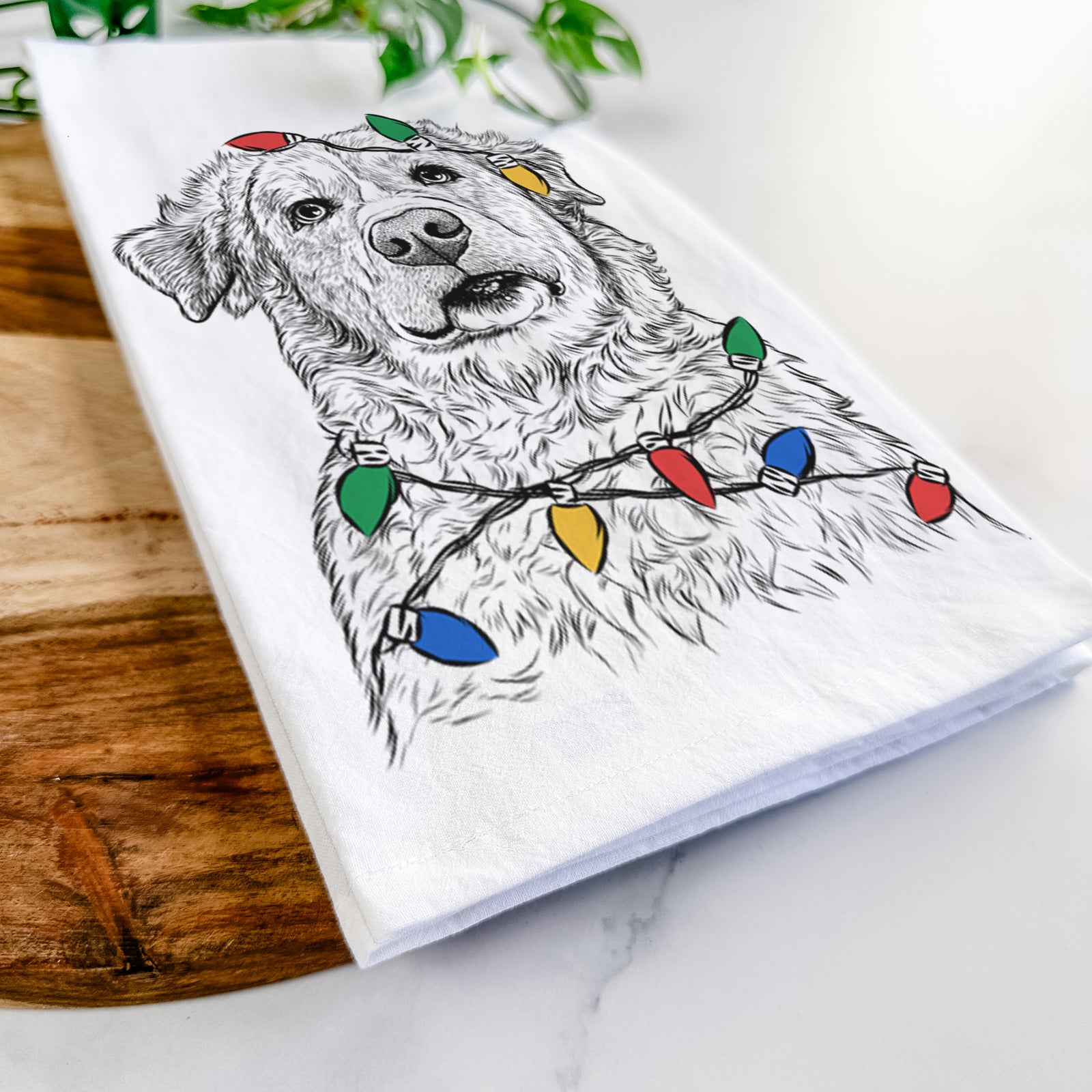 Hand-drawn sketch of Smokey Jam the Middle Eastern Village Dog wrapped in Christmas lights on a tea towel