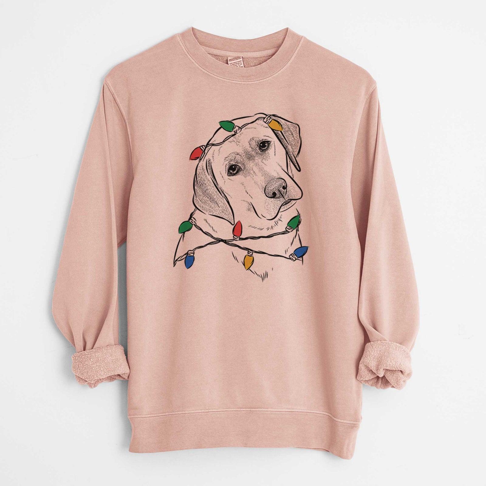 Hand-drawn sketch of Stella the Yellow Lab wrapped in Christmas lights on a Dusty Pink Unisex pigment dyed crew sweatshirt