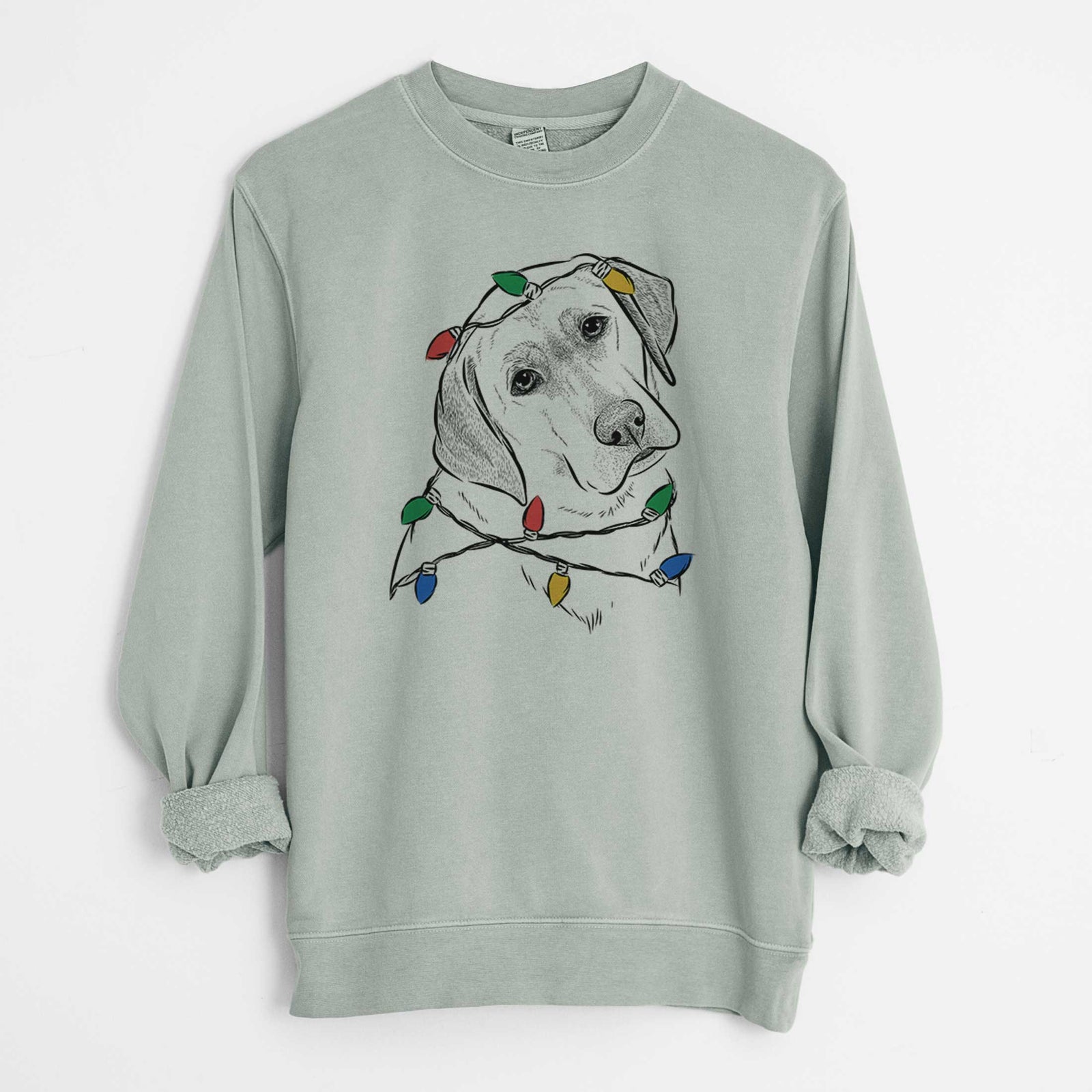 Hand-drawn sketch of Stella the Yellow Lab wrapped in Christmas lights on a Sage Unisex pigment dyed crew sweatshirt