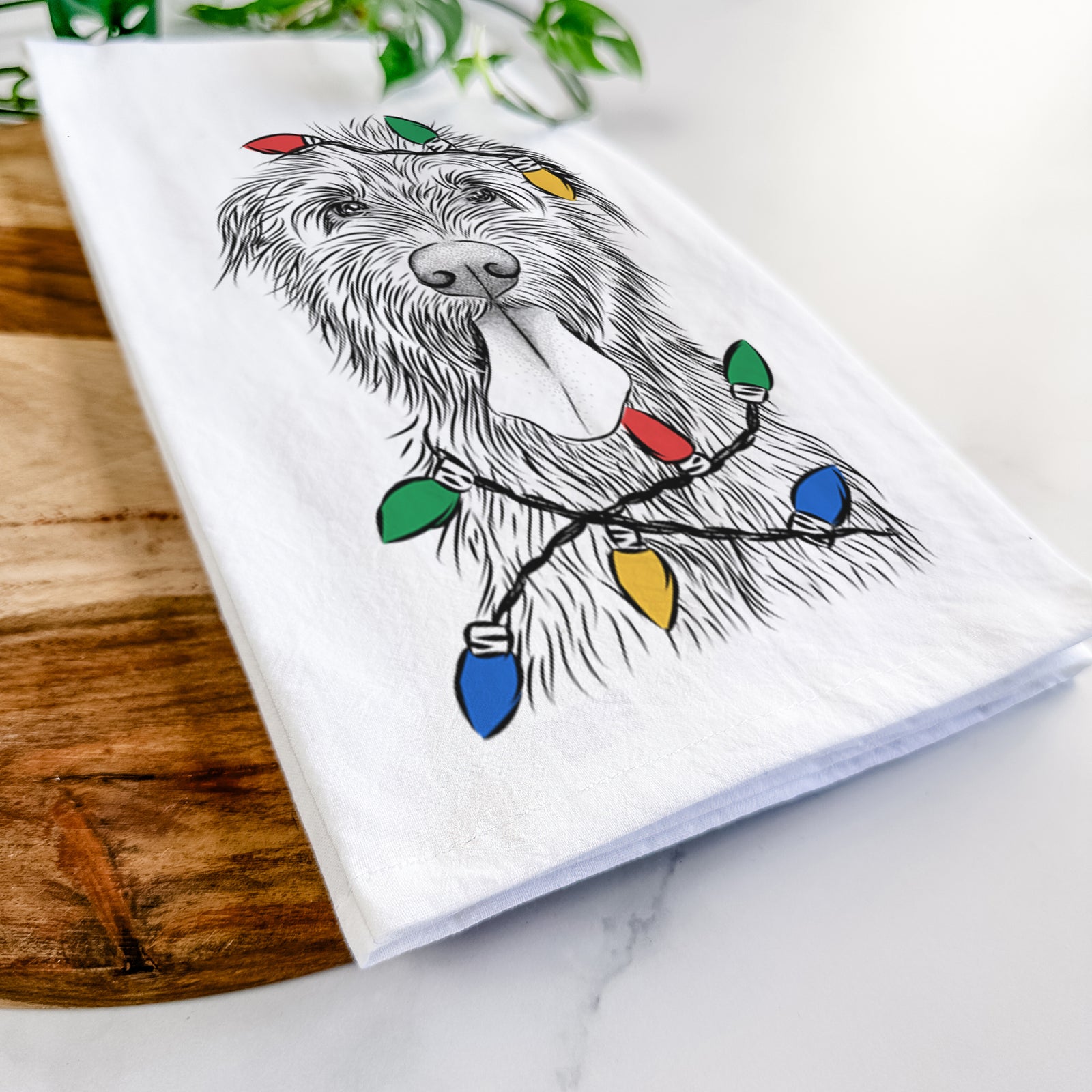Hand-drawn sketch of Sullivan the Irish Wolfhound wrapped in Christmas lights on a tea towel