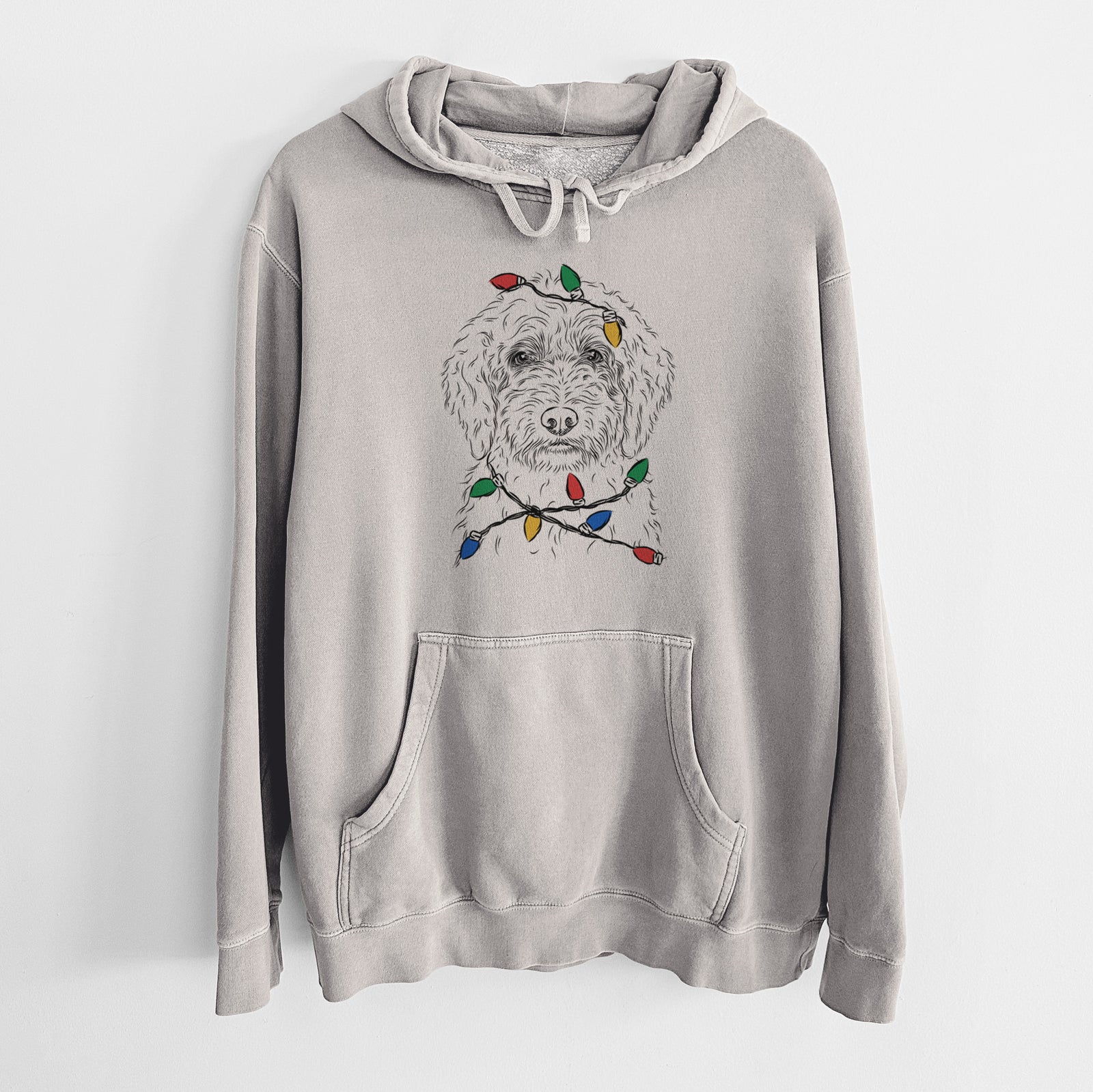 Hand-drawn sketch of Teddy the Labradoodle wrapped in Christmas lights on a Cement Unisex pigment dyed hoodie