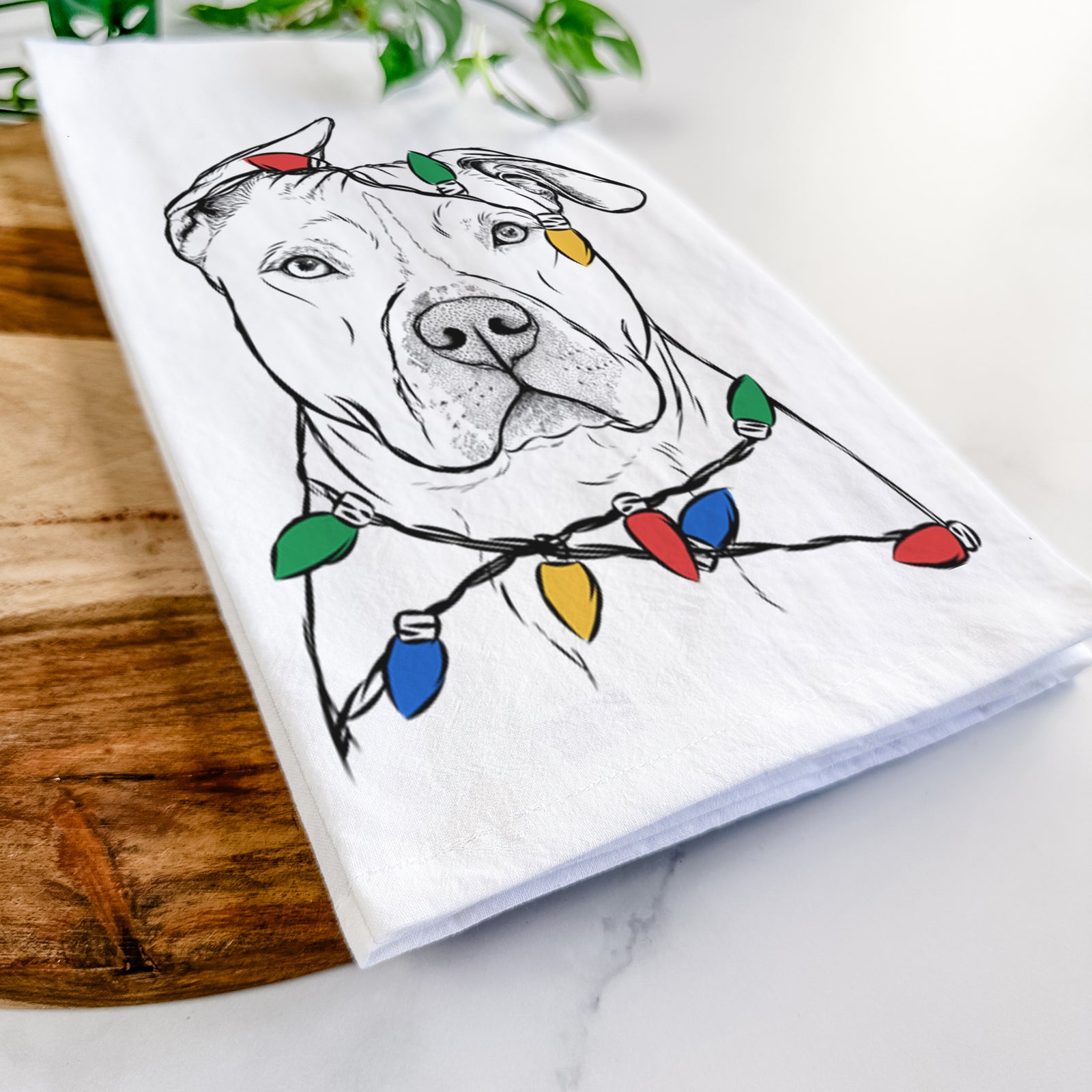 Hand-drawn sketch of Teddy Jam the Pitbull wrapped in Christmas lights on a tea towel