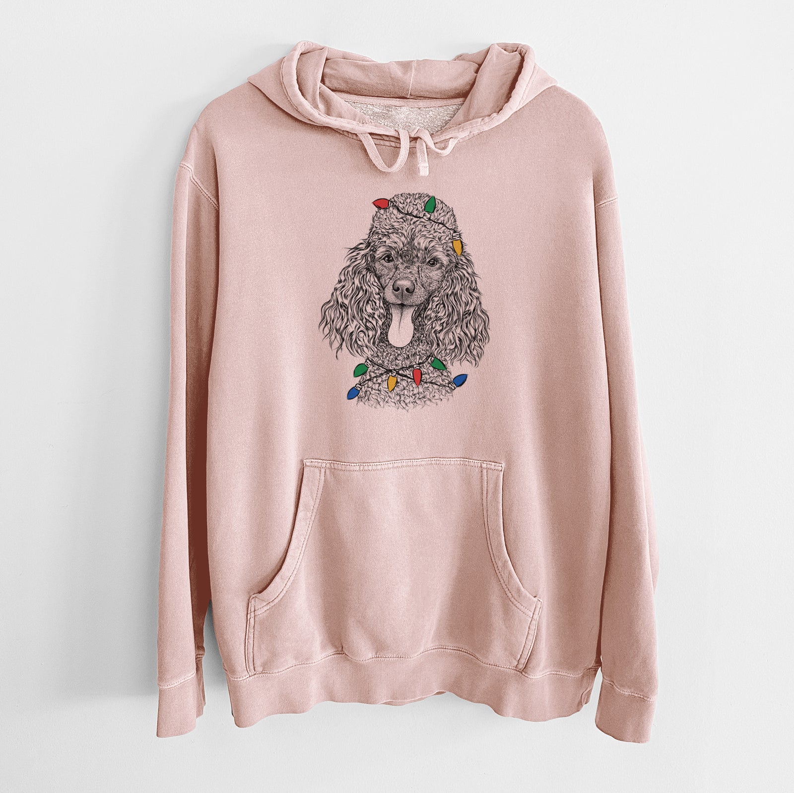 Hand-drawn sketch of Teddy the Mini Poodle wrapped in Christmas lights on a Dusty Pink Unisex pigment dyed hoodie