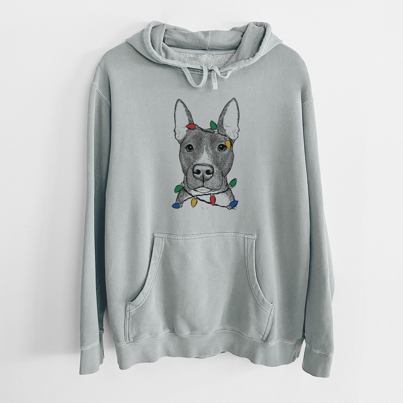 Hand-drawn sketch of Violet the Pitbull wrapped in Christmas lights on a Sage Unisex pigment dyed hoodie