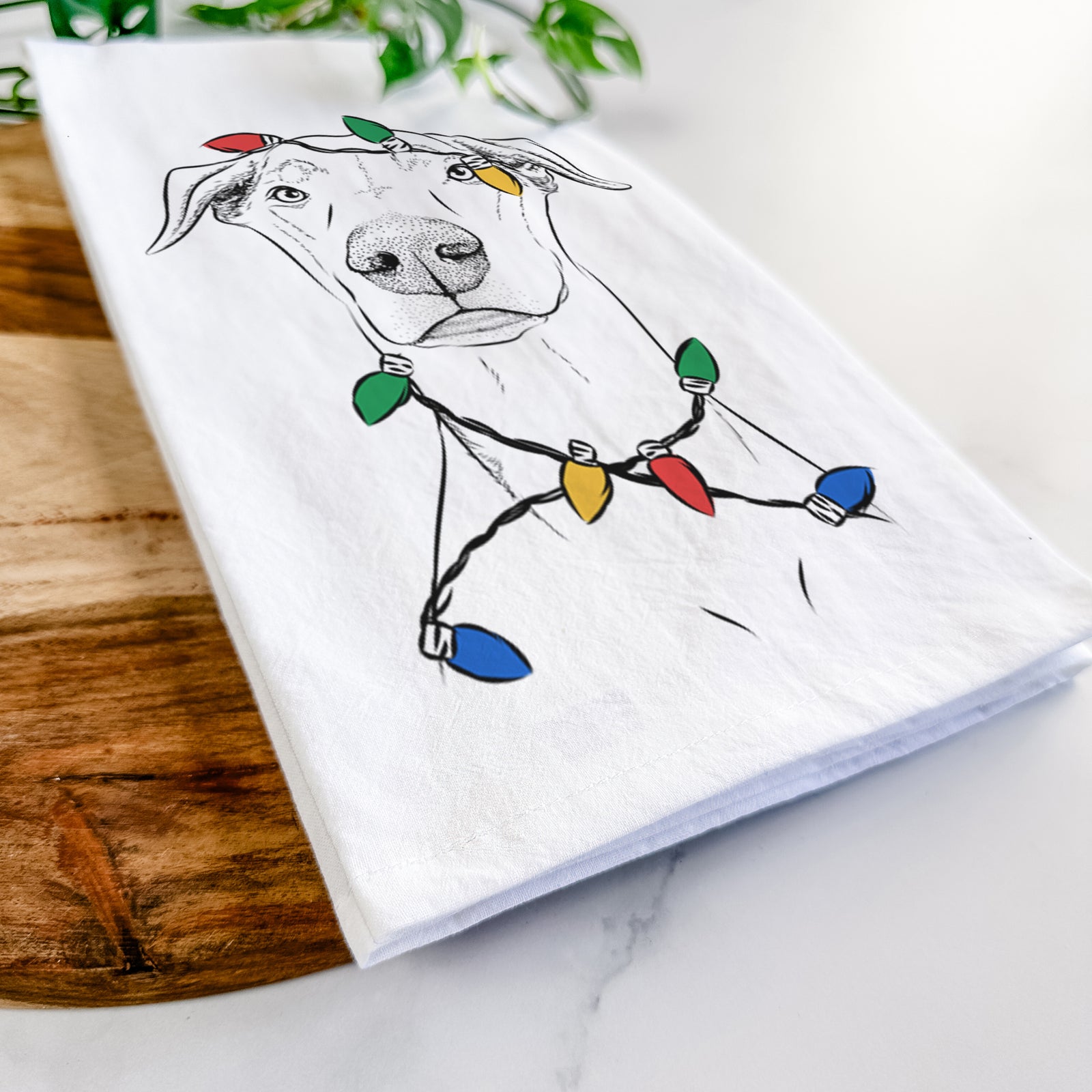 Hand-drawn sketch of Walter the White Doberman Rescue wrapped in Christmas lights on a tea towel