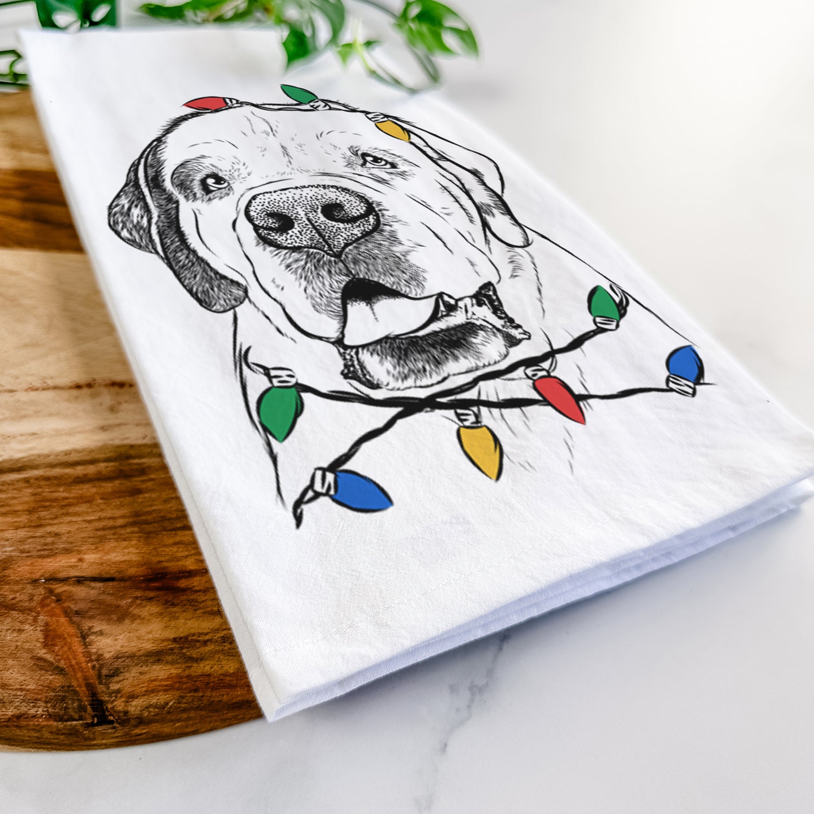 Hand-drawn sketch of Wendy the Saint Bernard wrapped in Christmas lights on a tea towel