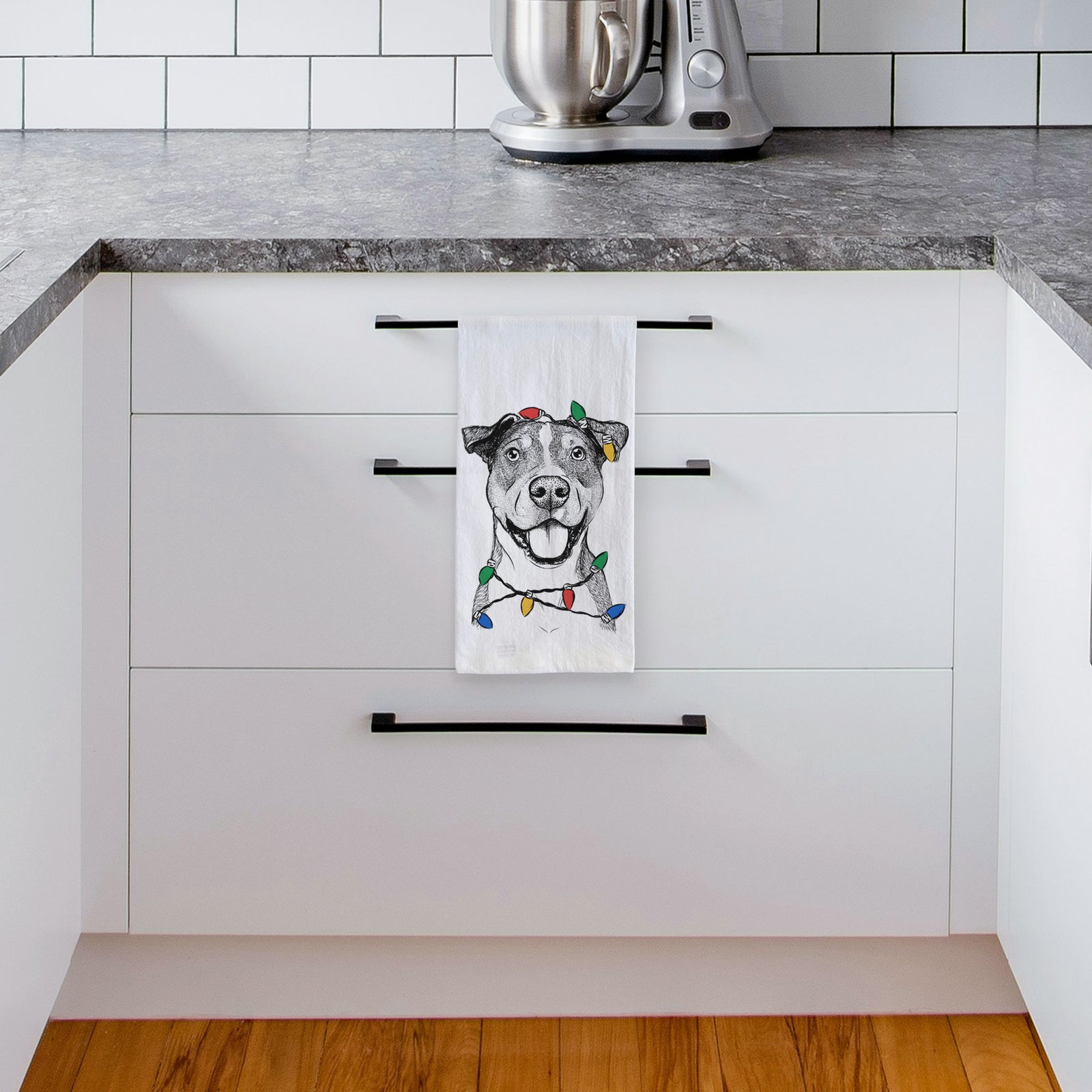 Hand-drawn sketch of Wendy the Mixed Breed wrapped in Christmas lights on a tea towel, hanging on an oven door in a kitchen