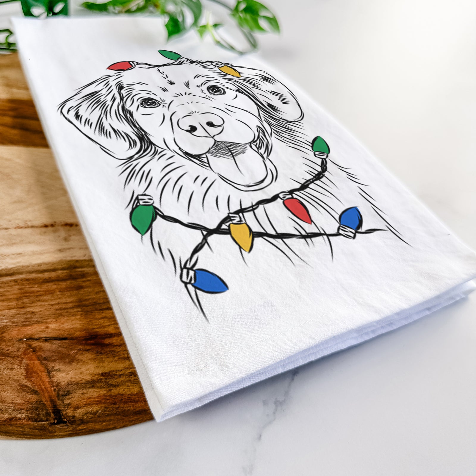 Hand-drawn sketch of Weston the Nova Scotia Duck Tolling Retriever wrapped in Christmas lights on a tea towel