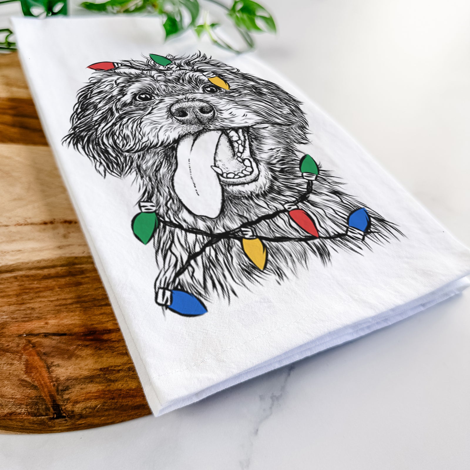 Hand-drawn sketch of Winnie the Mini Aussiedoodle wrapped in Christmas lights on a tea towel