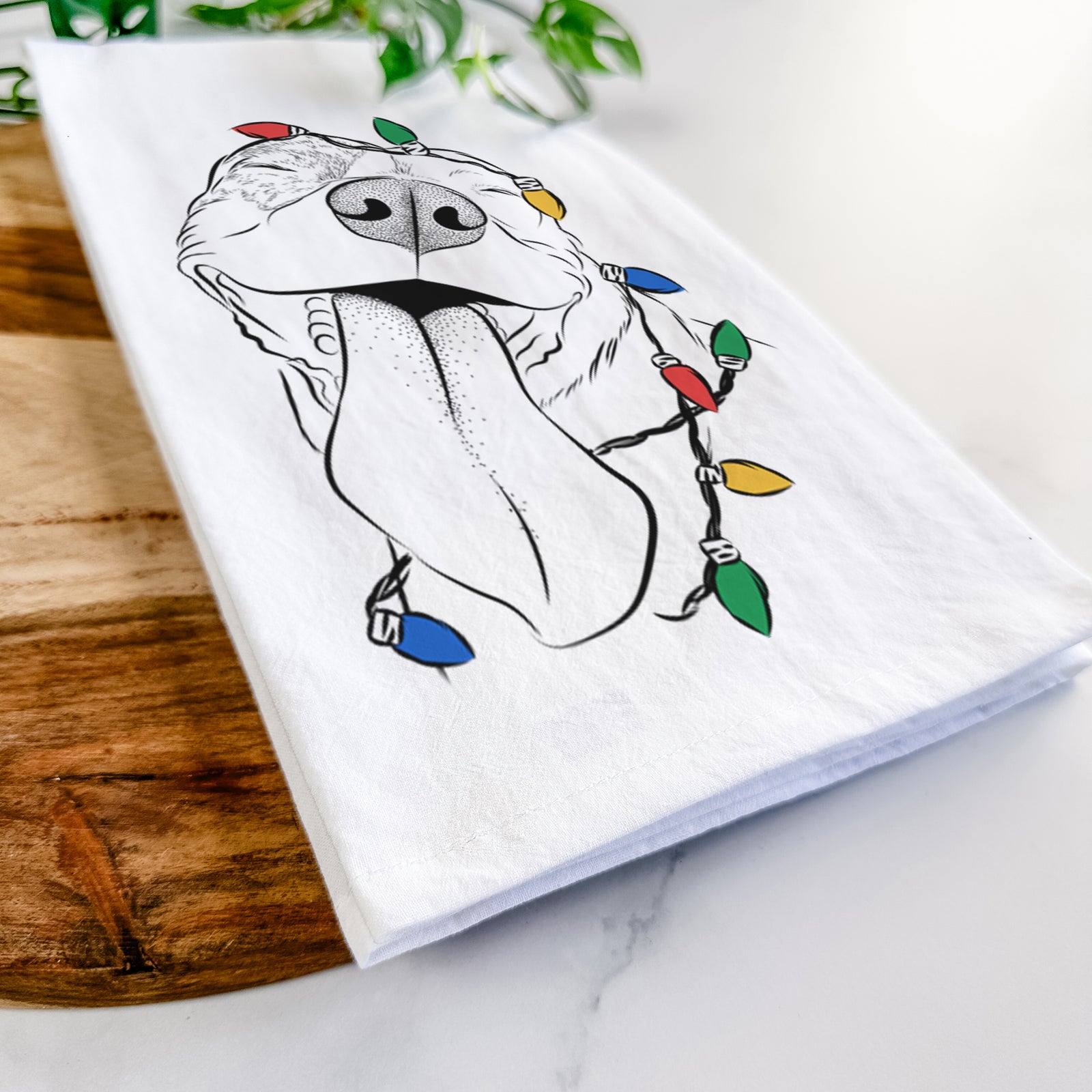 Hand-drawn sketch of Xena the American Staffordshire Terrier wrapped in Christmas lights on a tea towel