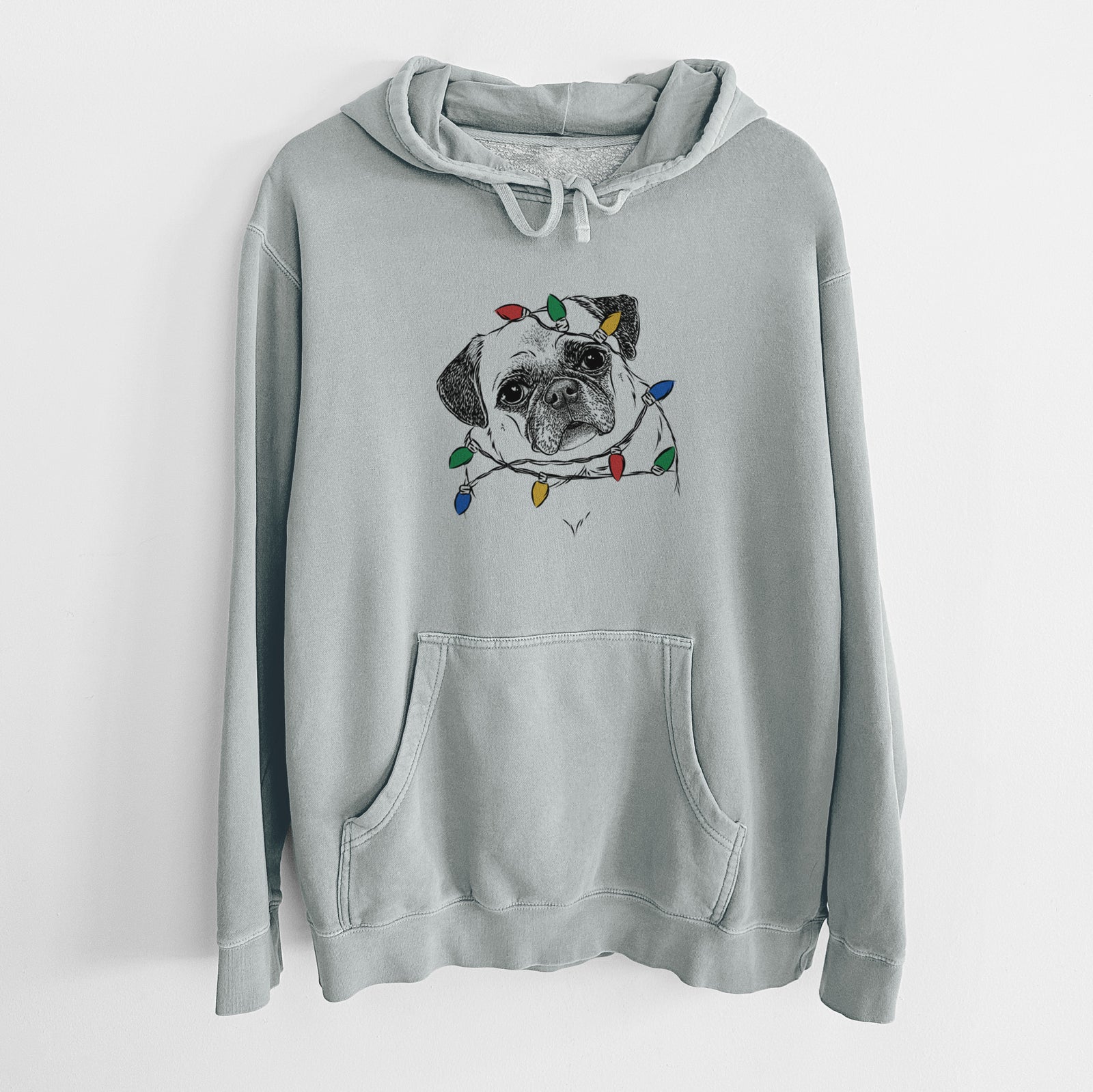 Hand-drawn sketch of Zoey the Pug wrapped in Christmas lights on a Sage Unisex pigment dyed hoodie