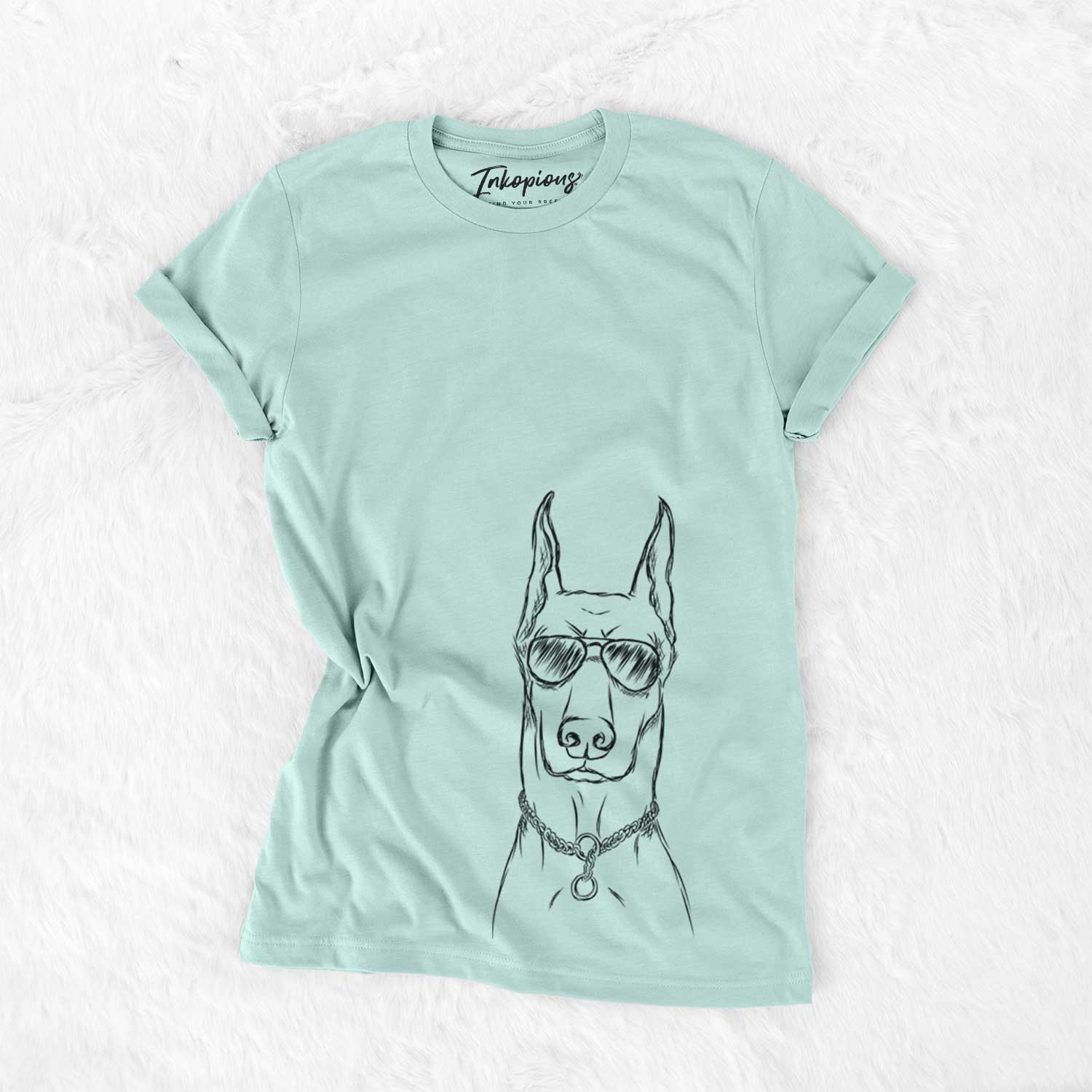 Hand-drawn sketch of Ace the Doberman Pinscher wearing aviator sunglasses on a Heather Sage Unisex crewneck
