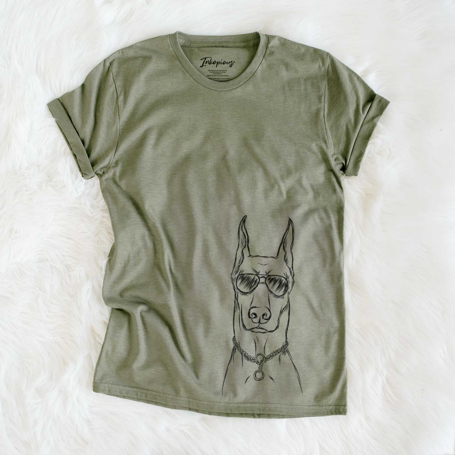 Hand-drawn sketch of Ace the Doberman Pinscher wearing aviator sunglasses on an Olive Unisex crewneck