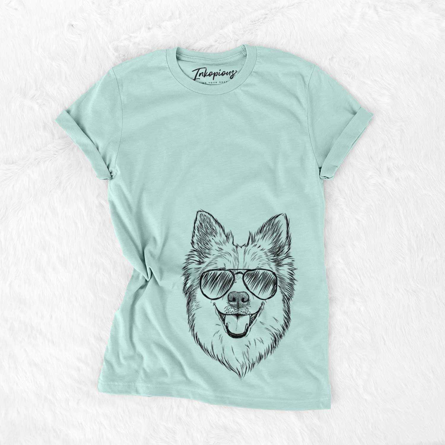 Hand-drawn sketch of Ari the Icelandic Sheepdog wearing aviator sunglasses on a Heather Sage Unisex crewneck