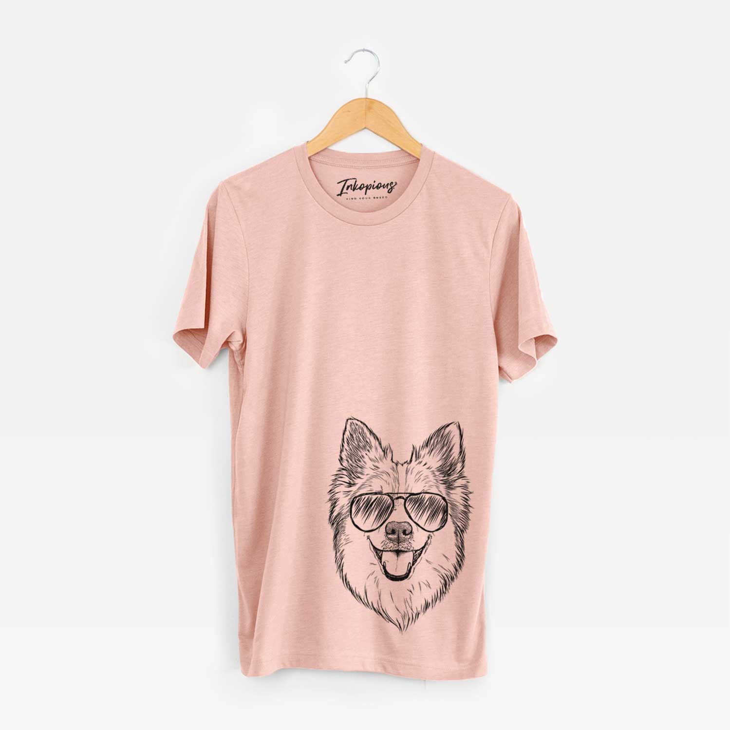 Hand-drawn sketch of Ari the Icelandic Sheepdog wearing aviator sunglasses on a Peach Unisex crewneck