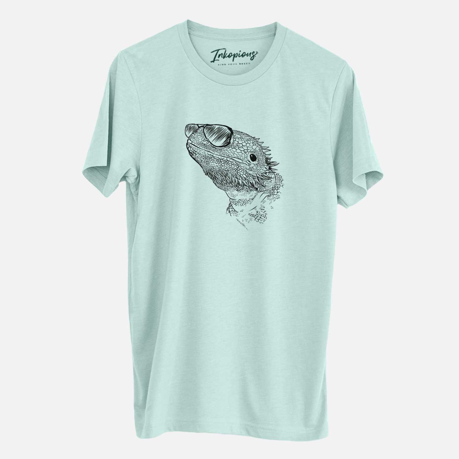 Hand-drawn sketch of Ash the Bearded Dragon wearing aviator sunglasses on a Heather Sage Unisex crewneck