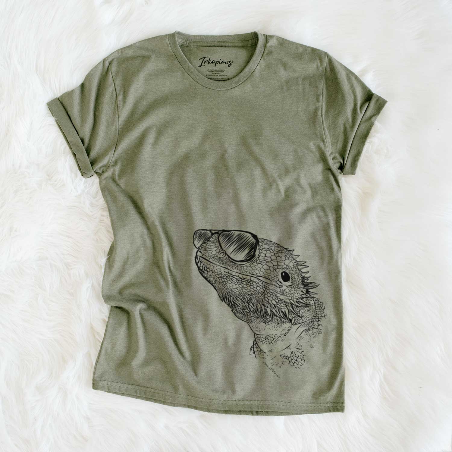Hand-drawn sketch of Ash the Bearded Dragon wearing aviator sunglasses on an Olive Unisex crewneck