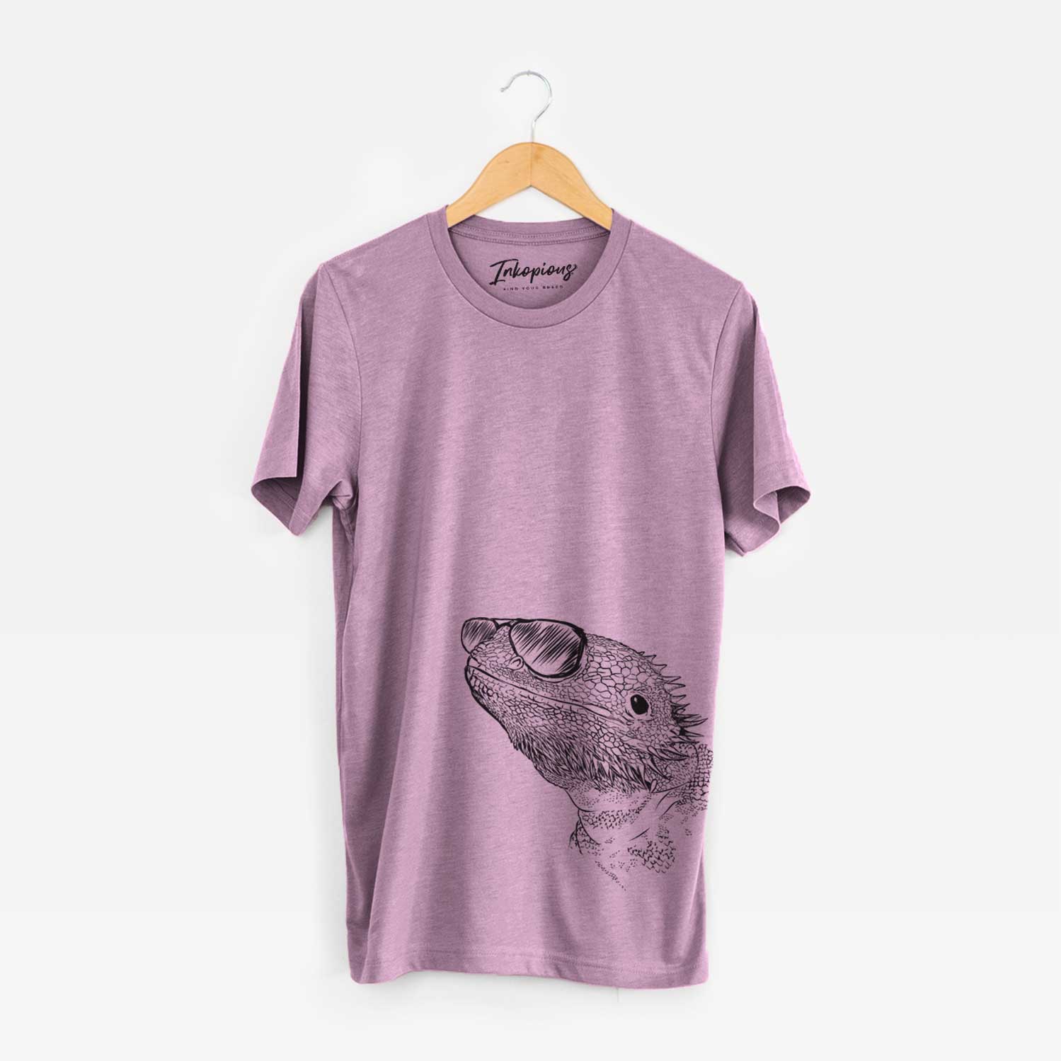 Hand-drawn sketch of Ash the Bearded Dragon wearing aviator sunglasses on an Orchid Unisex crewneck