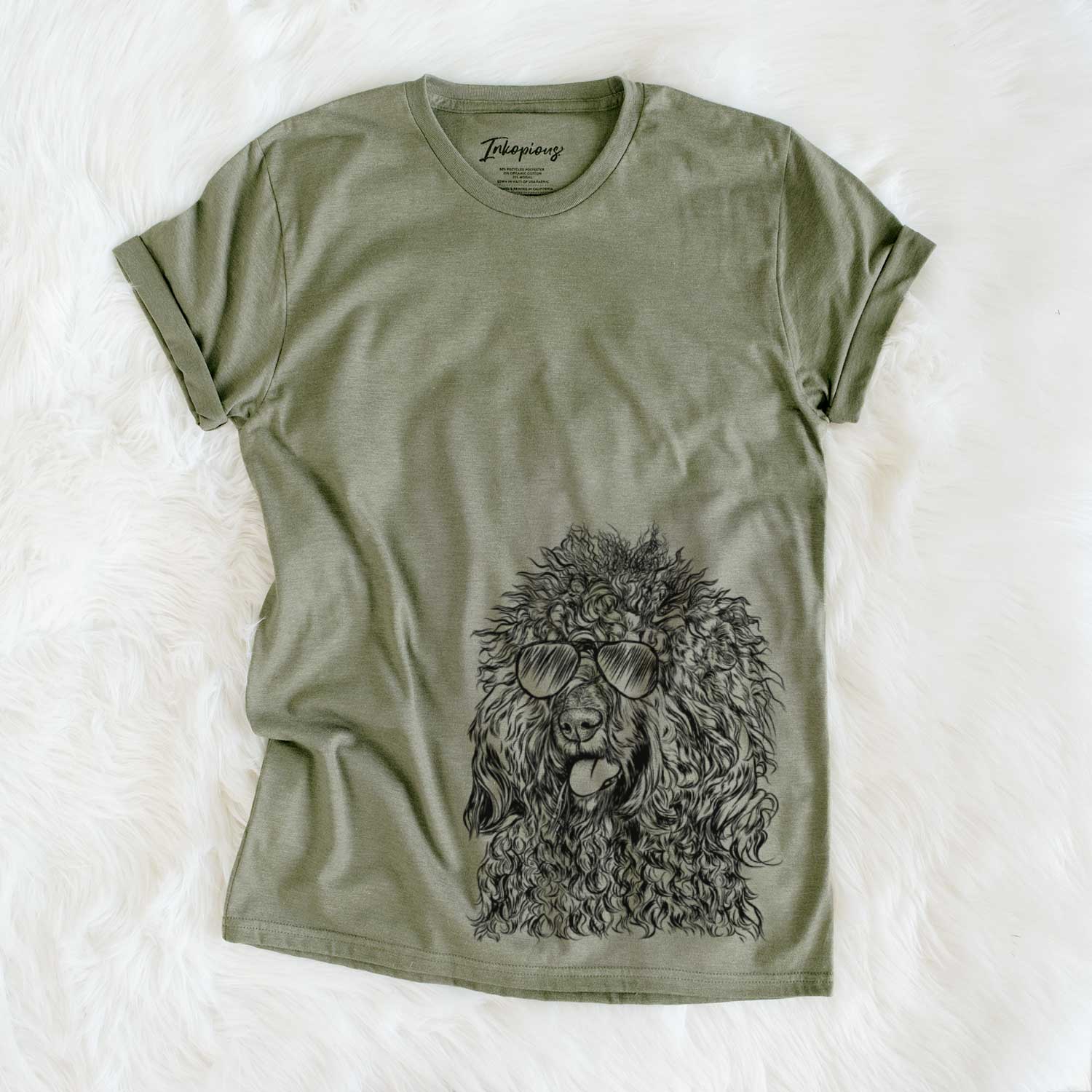 Hand-drawn sketch of Babs the Barbet wearing aviator sunglasses on an Olive Unisex crewneck