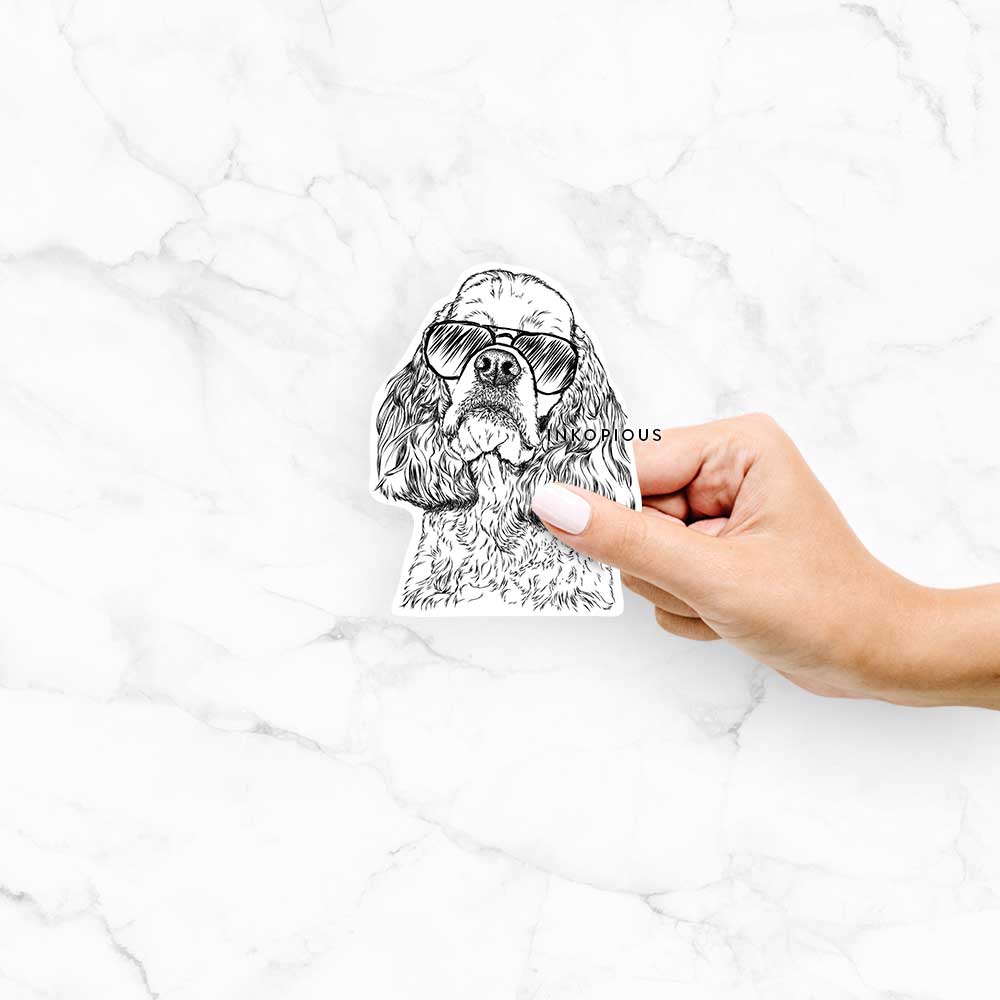 Hand-drawn sketch of Bailey the American Cocker Spaniel wearing aviator sunglasses on a decal sticker