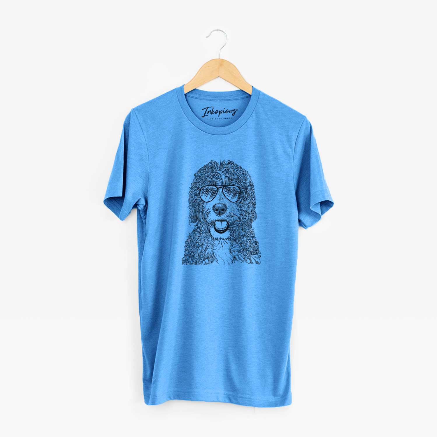 Hand-drawn sketch of Bash the Bernedoodle wearing aviator sunglasses on a Blue Unisex crewneck