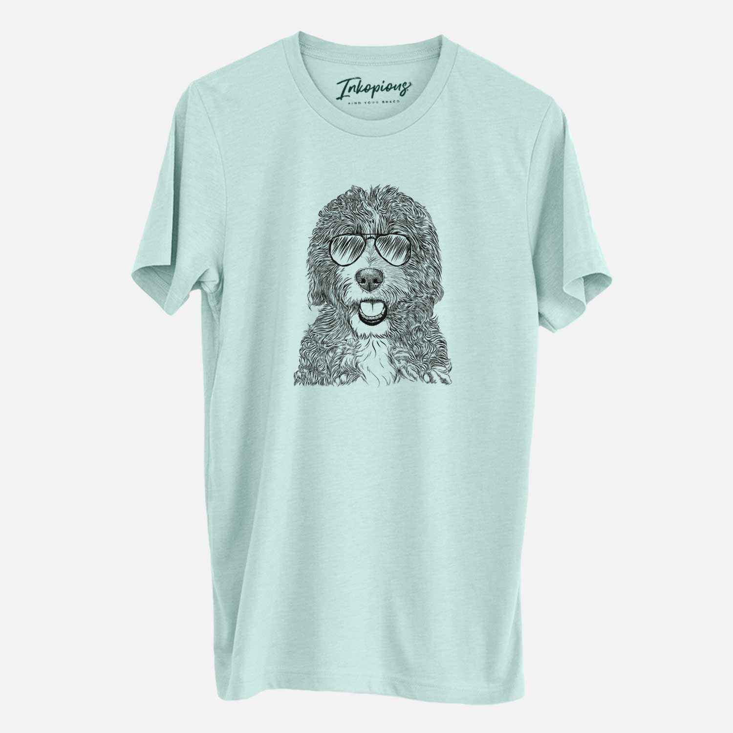 Hand-drawn sketch of Bash the Bernedoodle wearing aviator sunglasses on a Heather Sage Unisex crewneck