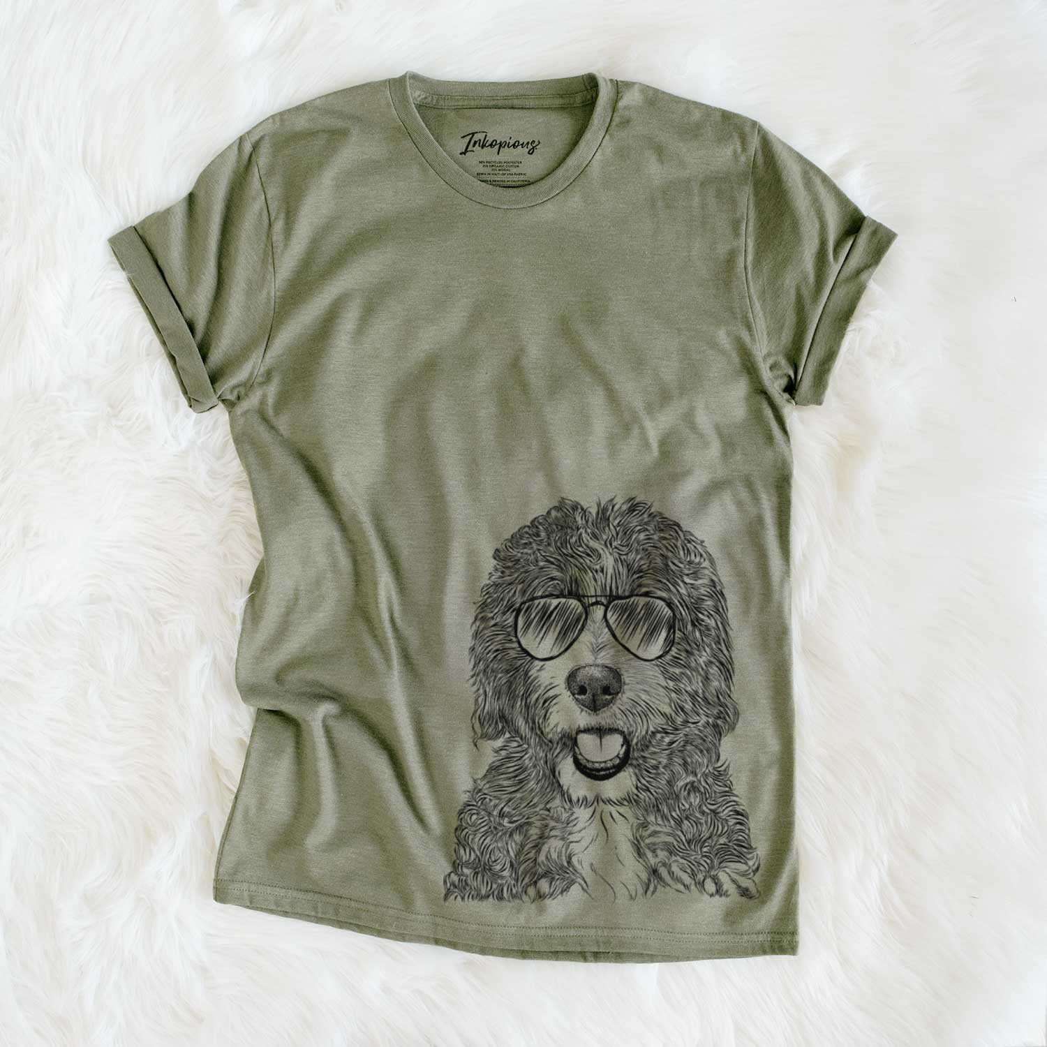 Hand-drawn sketch of Bash the Bernedoodle wearing aviator sunglasses on an Olive Unisex crewneck
