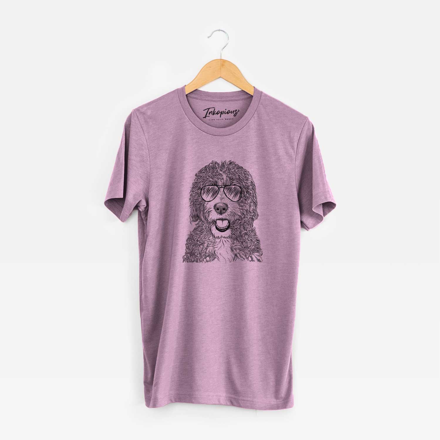 Hand-drawn sketch of Bash the Bernedoodle wearing aviator sunglasses on an Orchid Unisex crewneck