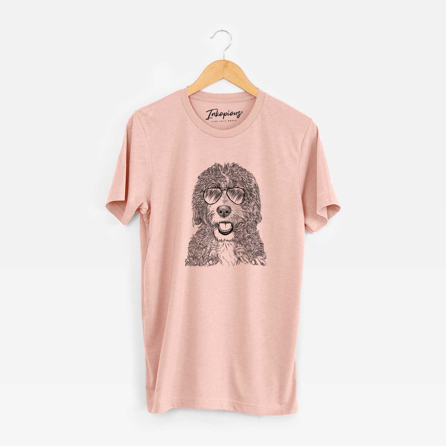 Hand-drawn sketch of Bash the Bernedoodle wearing aviator sunglasses on a Peach Unisex crewneck
