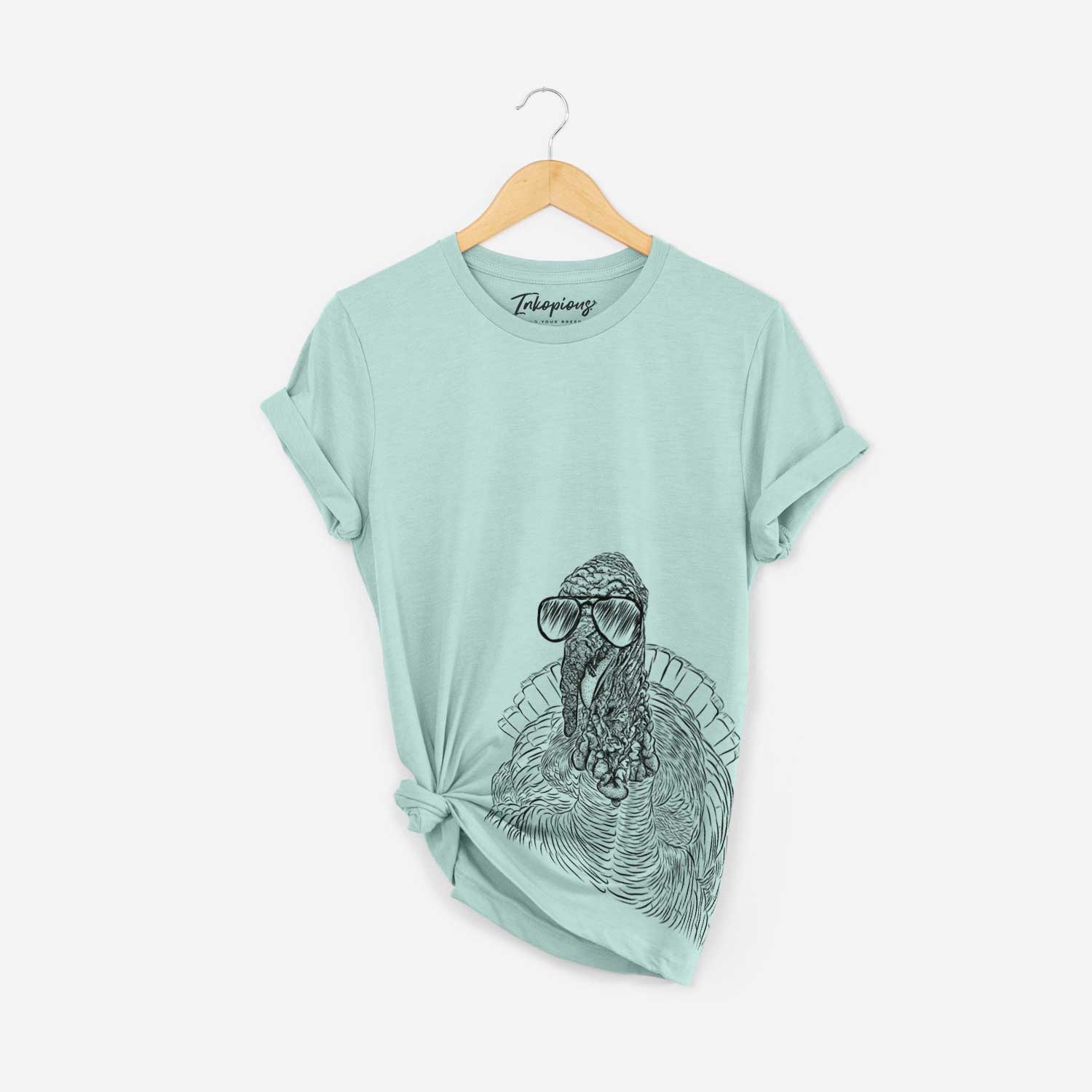 Hand-drawn sketch of Brady the Turkey wearing aviator sunglasses on a Heather Sage Bella Canvas Unisex Crewneck