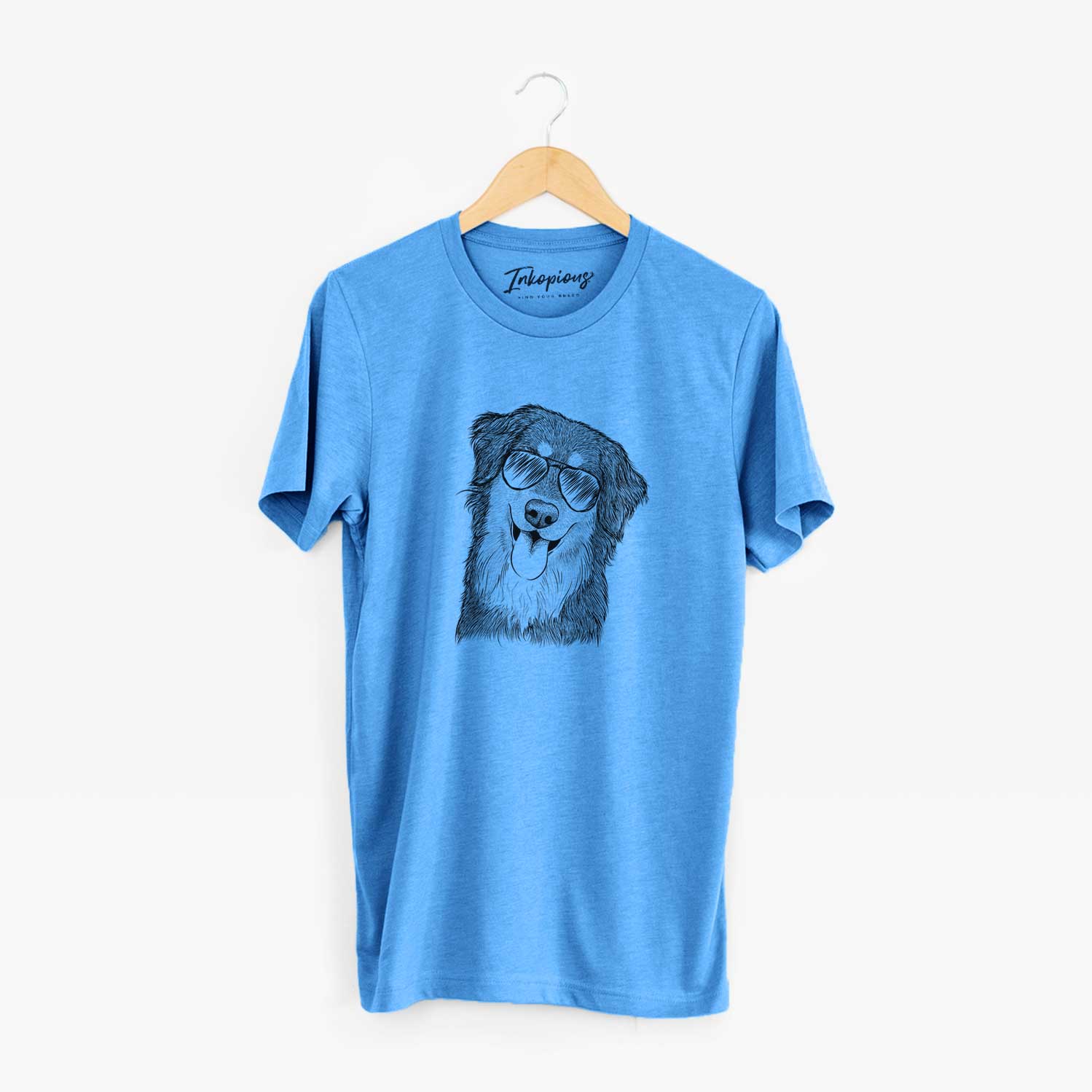 Hand-drawn sketch of Brodie the Golden Aussie wearing aviator sunglasses on a Blue Unisex crewneck