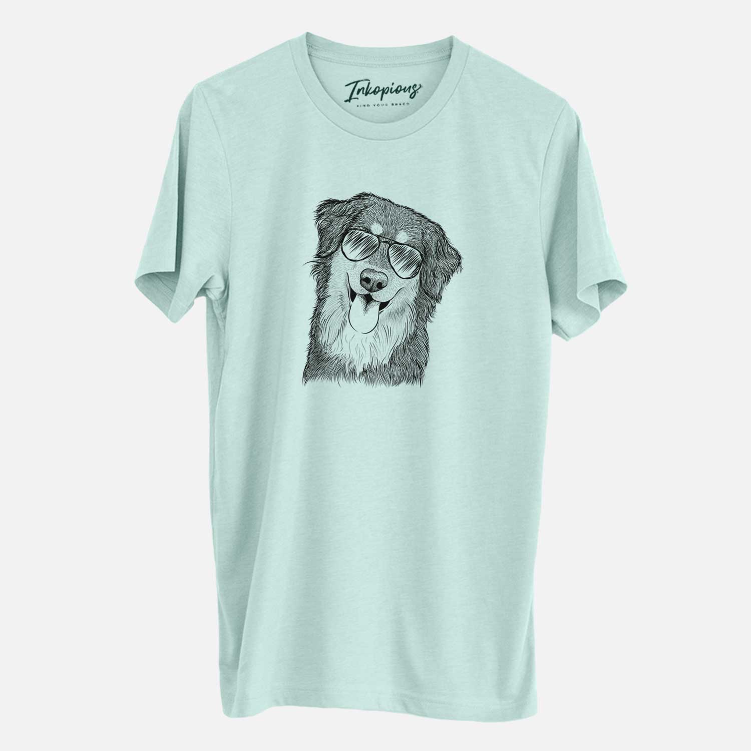 Hand-drawn sketch of Brodie the Golden Aussie wearing aviator sunglasses on a Heather Sage Unisex crewneck
