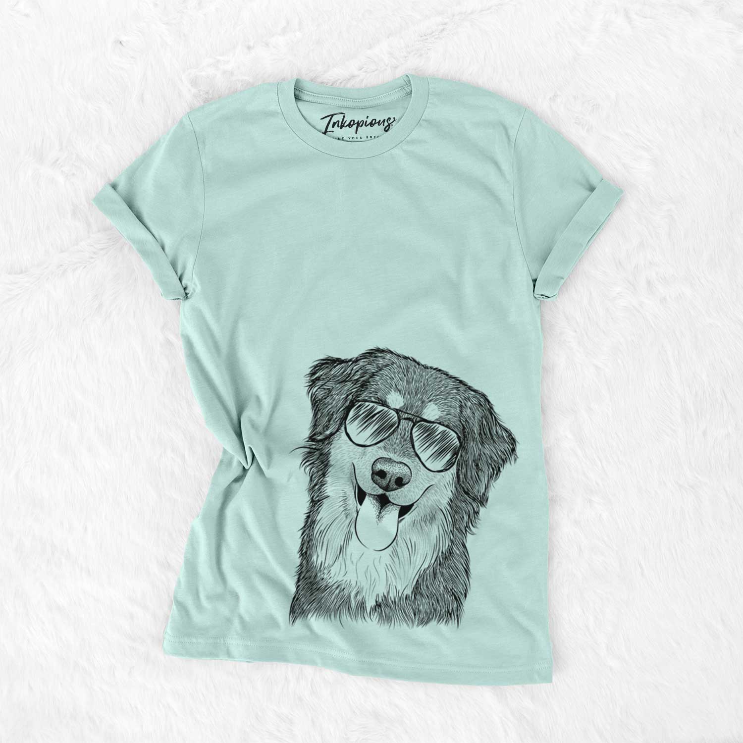 Hand-drawn sketch of Brodie the Golden Aussie wearing aviator sunglasses on a Heather Sage Unisex crewneck