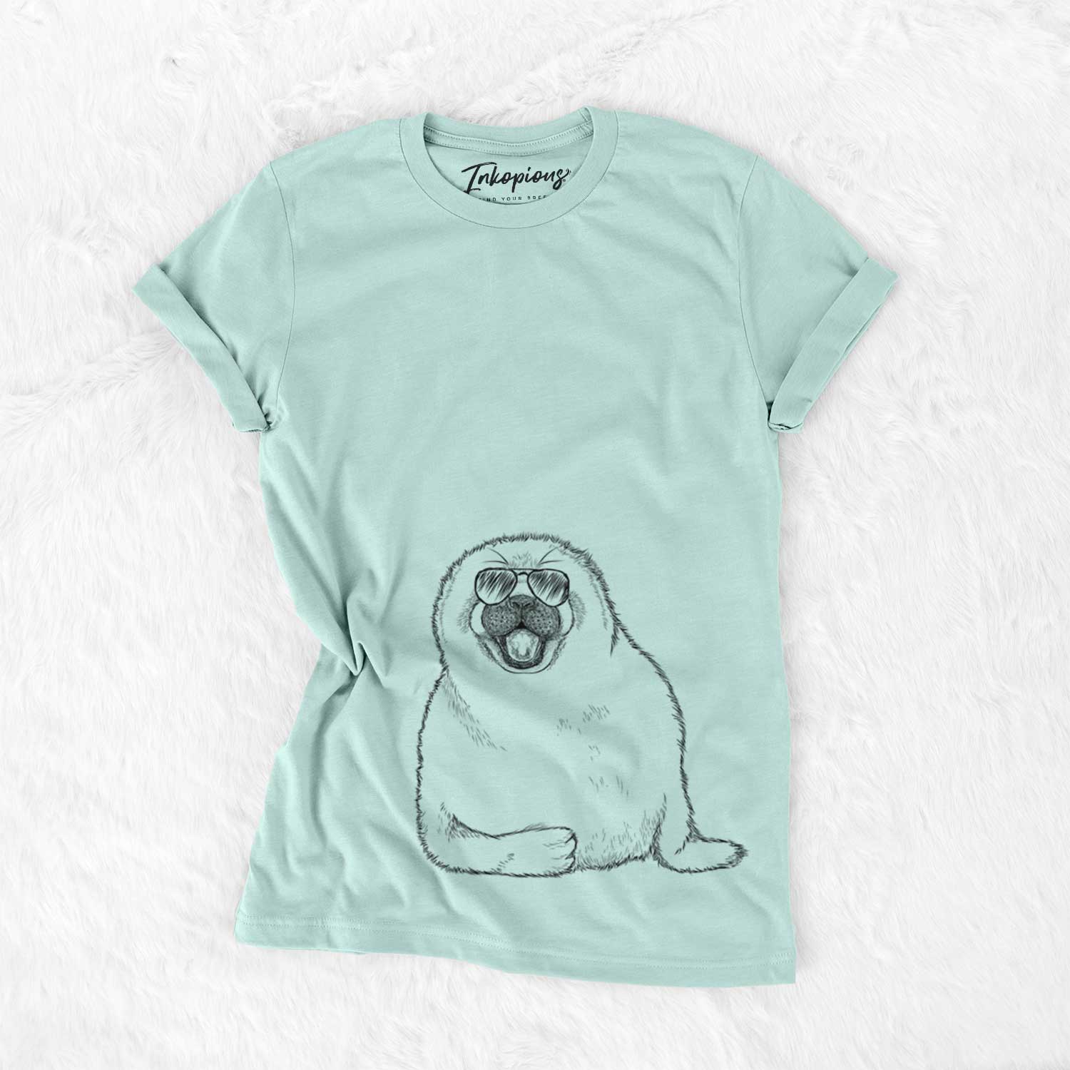 Hand-drawn sketch of Bub the Harp Seal wearing aviator sunglasses on a Heather Sage Unisex crewneck