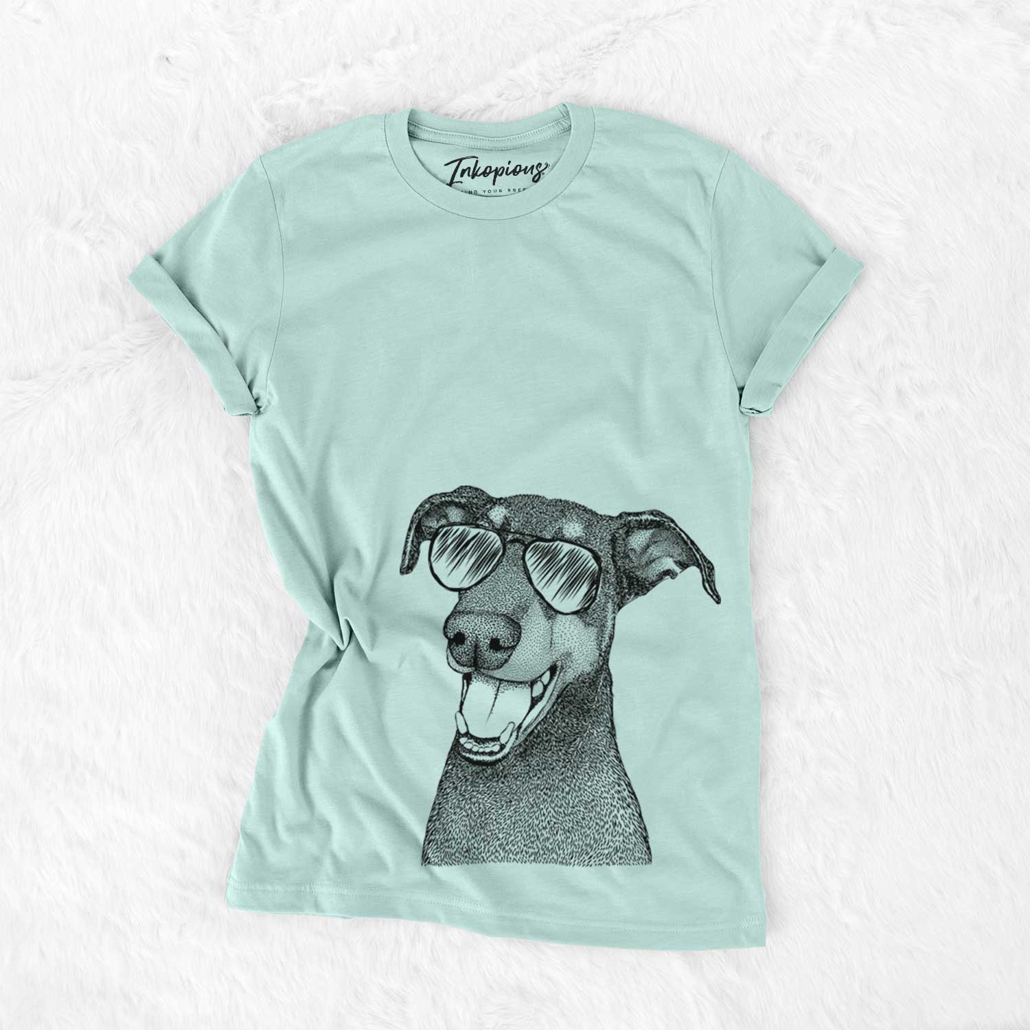 Hand-drawn sketch of Bunnie the Doberman Pinscher wearing aviator sunglasses on a Heather Sage Unisex crewneck