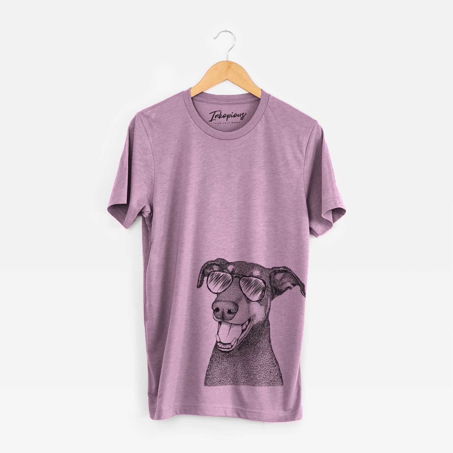 Hand-drawn sketch of Bunnie the Doberman Pinscher wearing aviator sunglasses on an Orchid Unisex crewneck