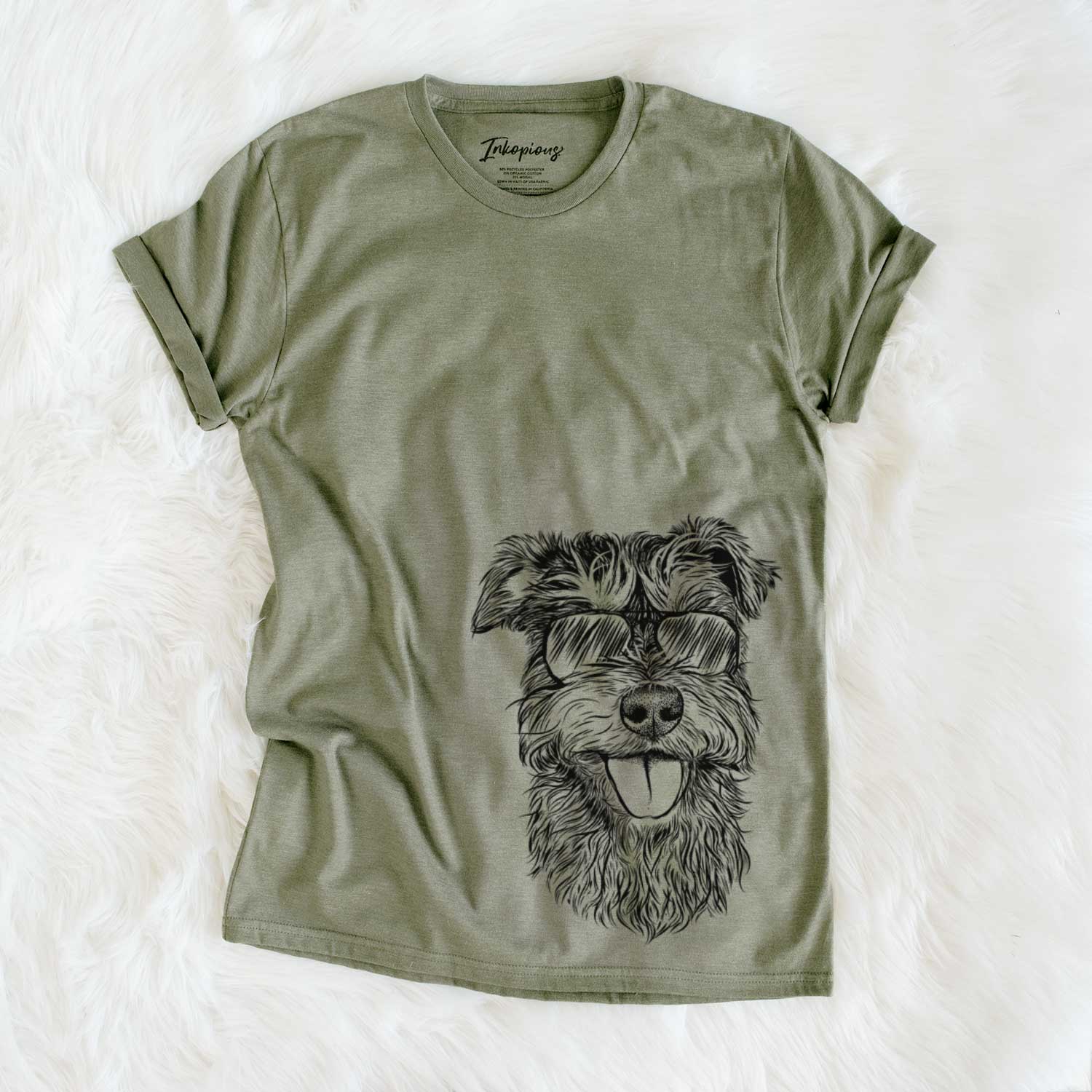 Hand-drawn sketch of Buster the Schnoodle wearing aviator sunglasses on an Olive Unisex crewneck