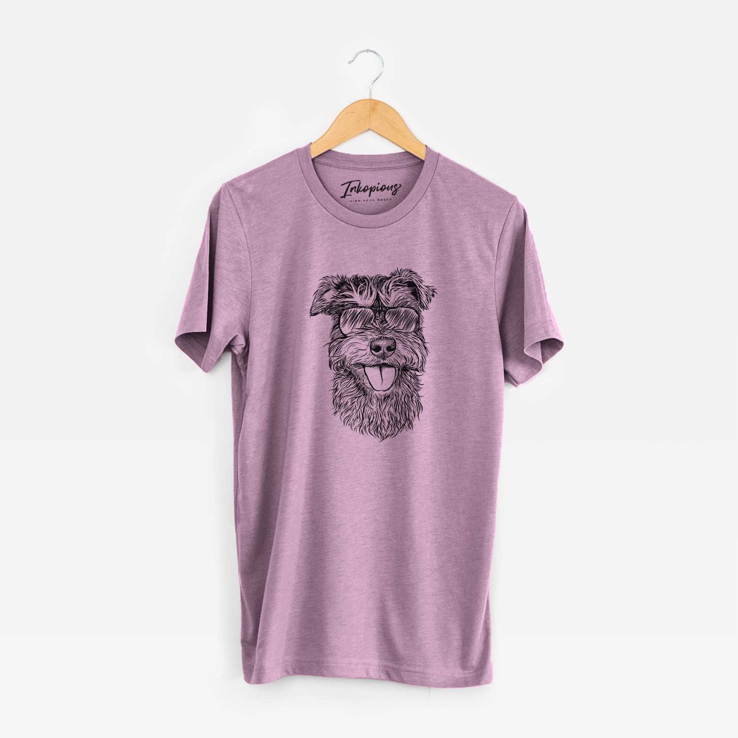 Hand-drawn sketch of Buster the Schnoodle wearing aviator sunglasses on an Orchid Unisex crewneck