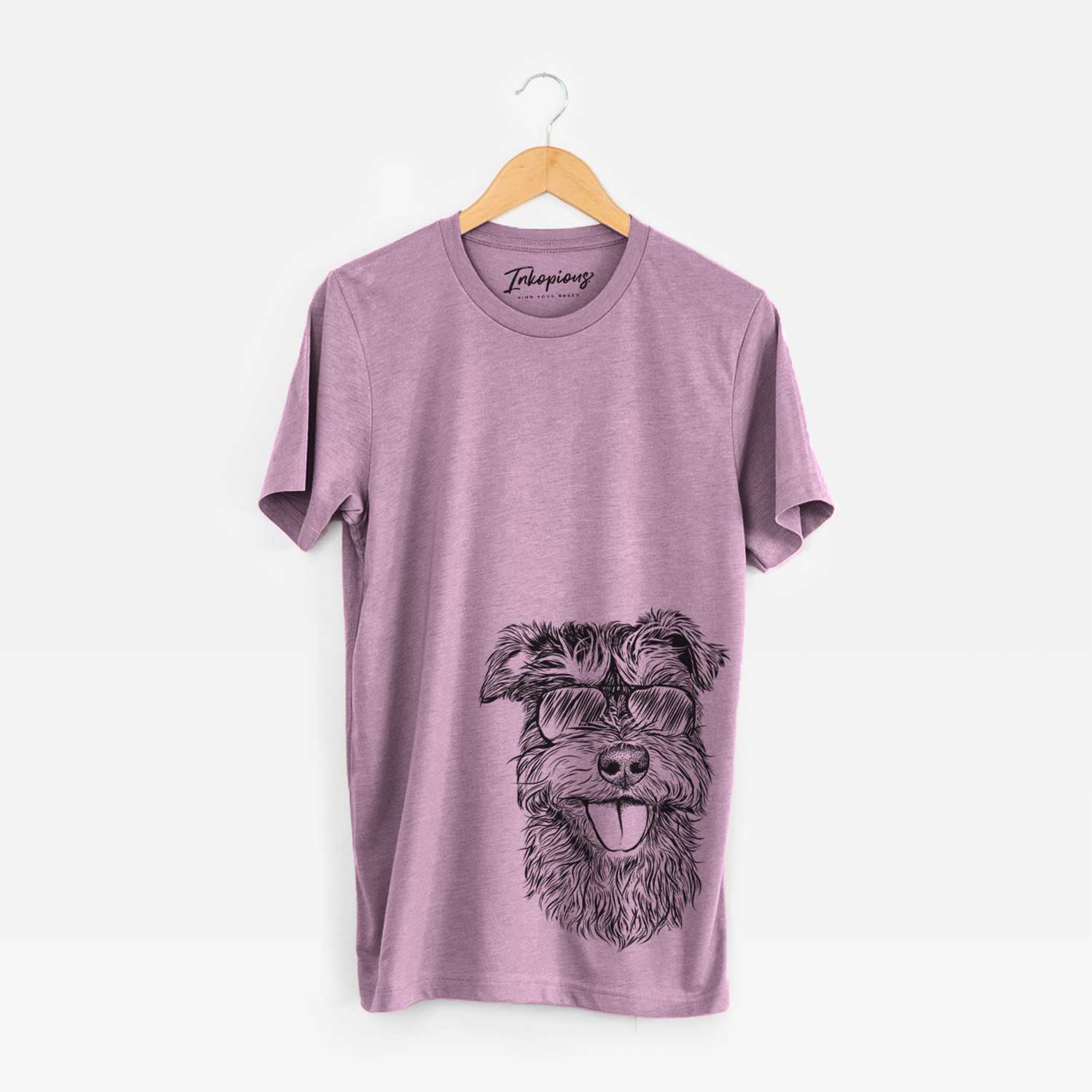 Hand-drawn sketch of Buster the Schnoodle wearing aviator sunglasses on an Orchid Unisex crewneck