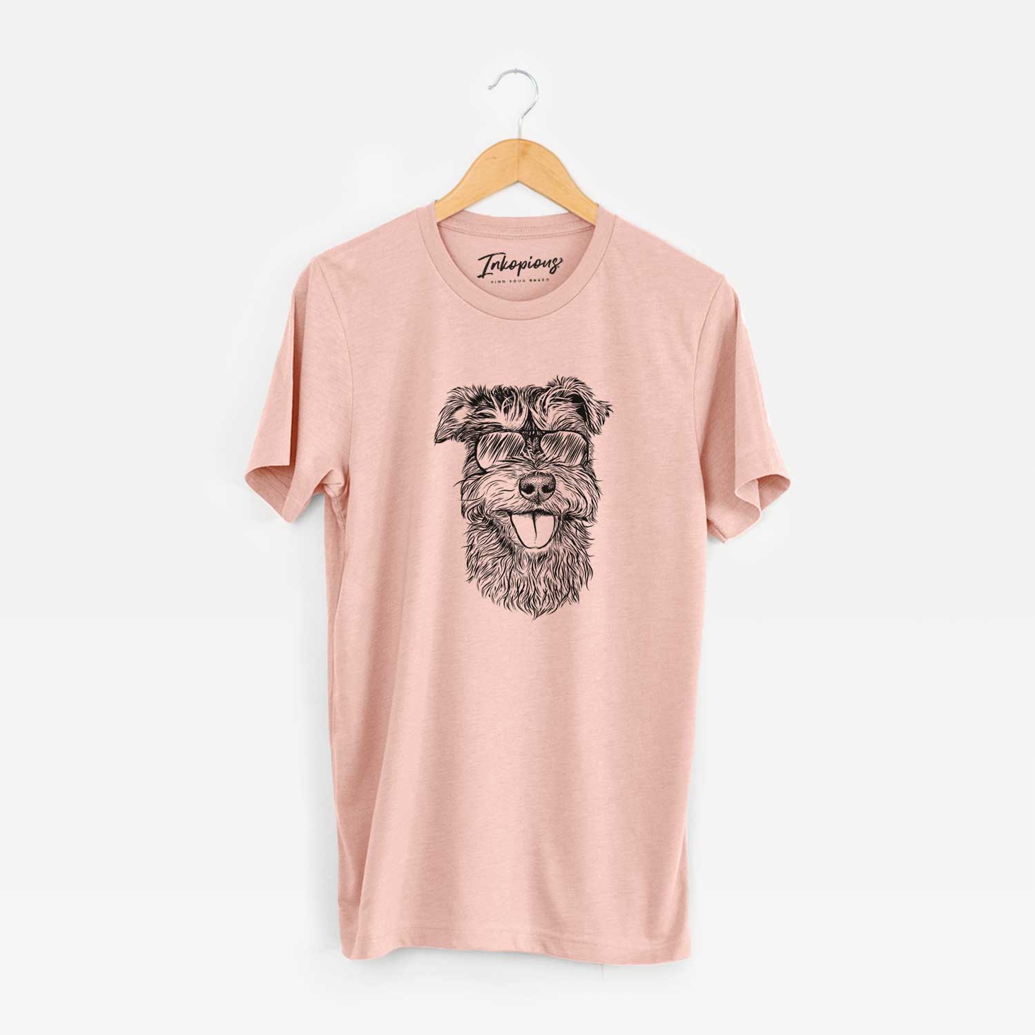 Hand-drawn sketch of Buster the Schnoodle wearing aviator sunglasses on a Peach Unisex crewneck