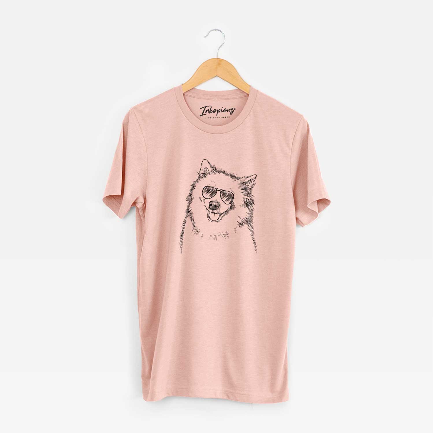 Hand-drawn sketch of Caico the Samoyed wearing aviator sunglasses on a Peach Unisex crewneck